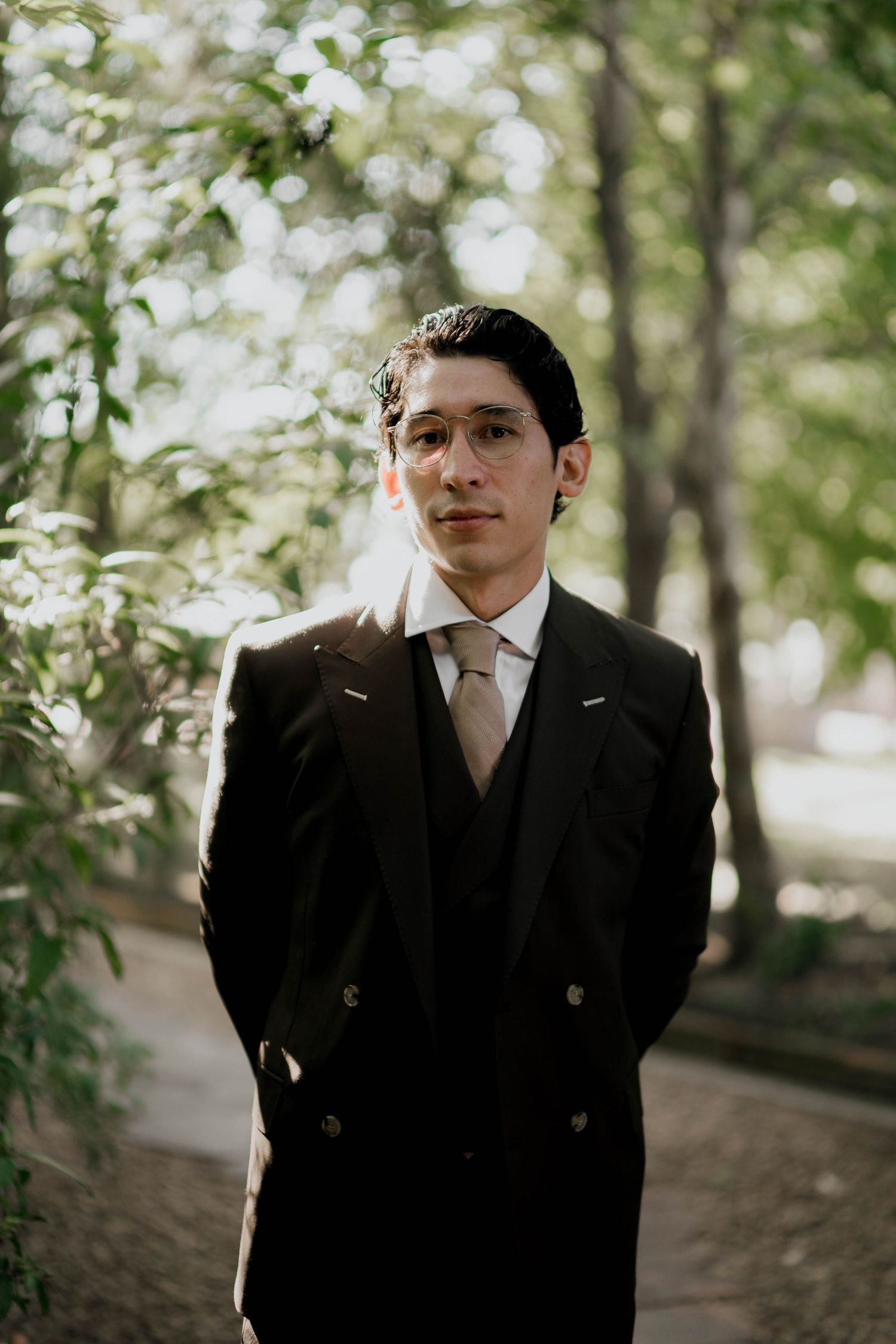 Artistic portrait series in a wooded setting with natural lighting and formal attire.