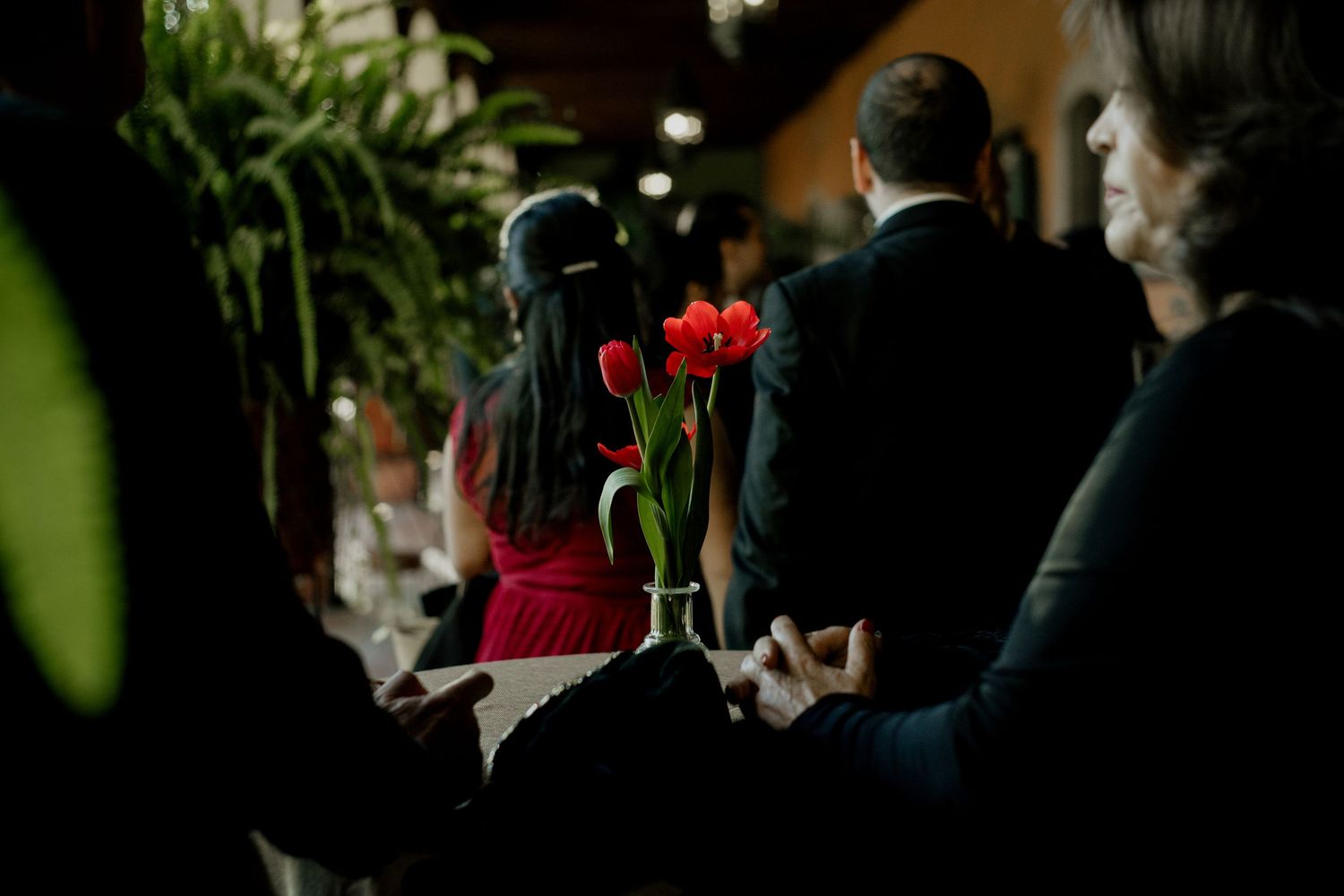Dark and moody wedding reception setting with elegant table decorations.