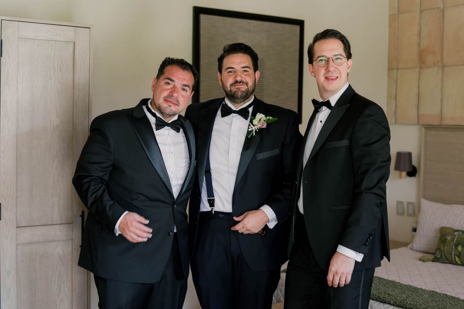 A group wearing formal attire gathered in an elegantly decorated interior space.