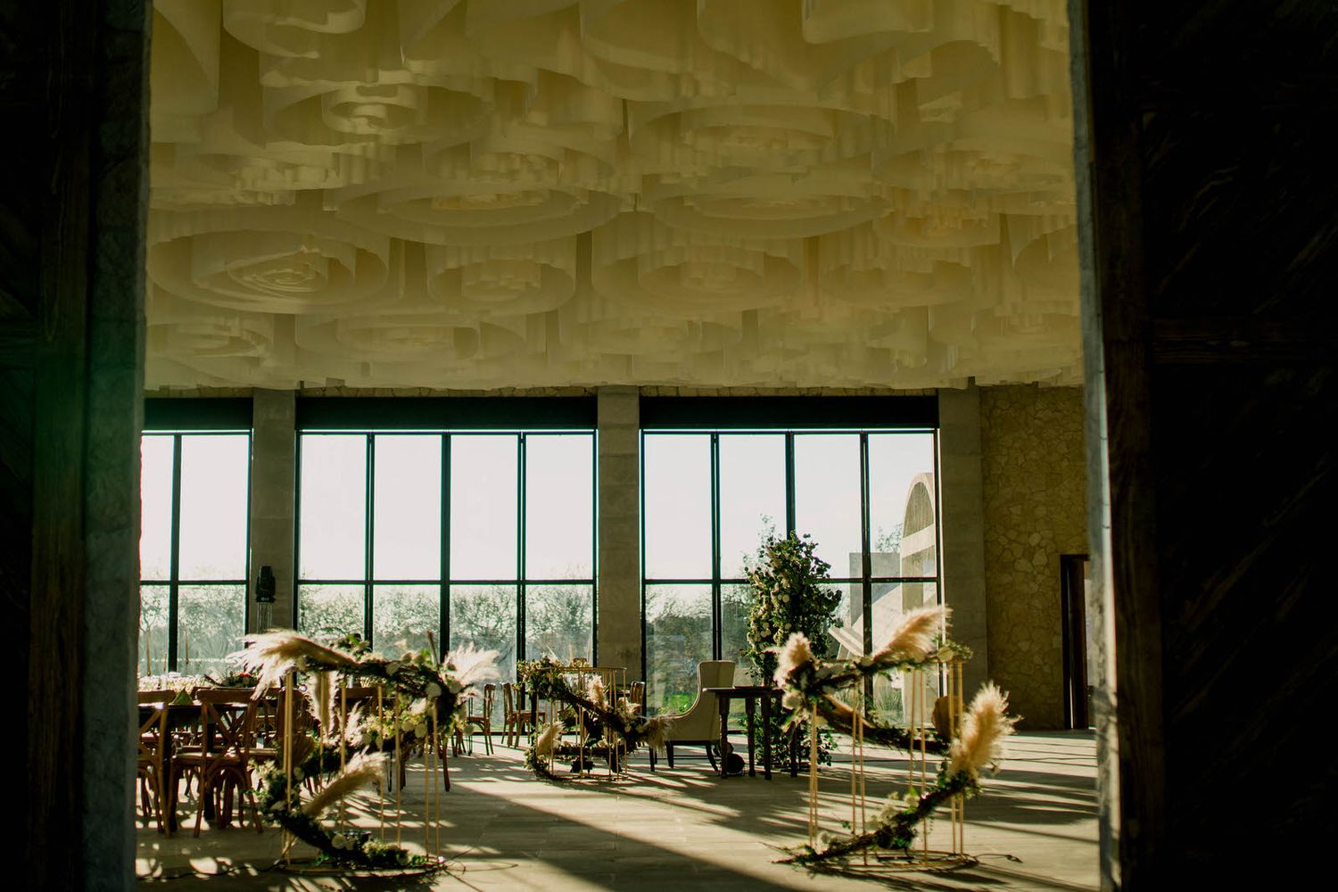 Large industrial venue space with floor-to-ceiling windows and event setup.