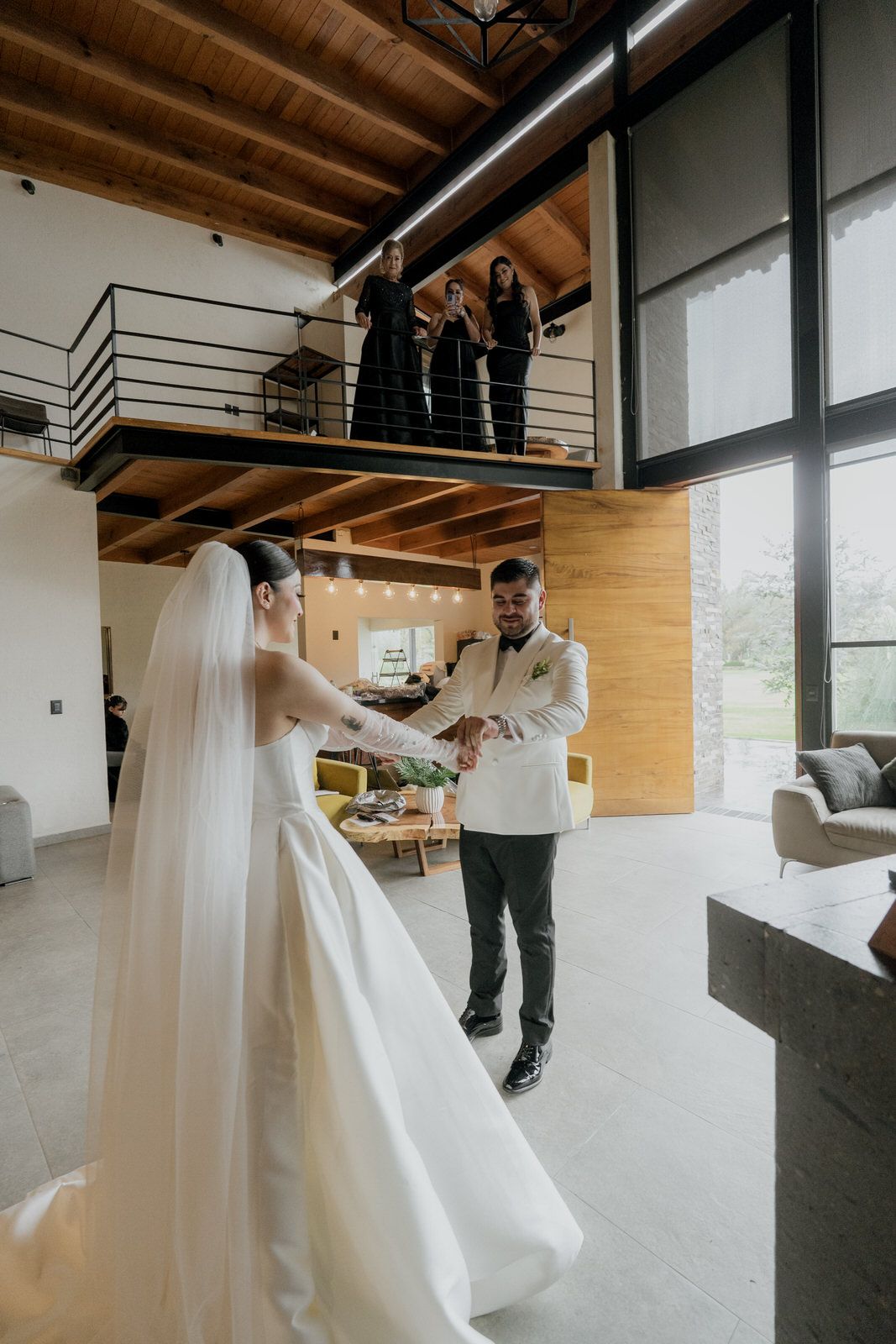 Wedding couple sharing a moment in modern venue with mezzanine level.