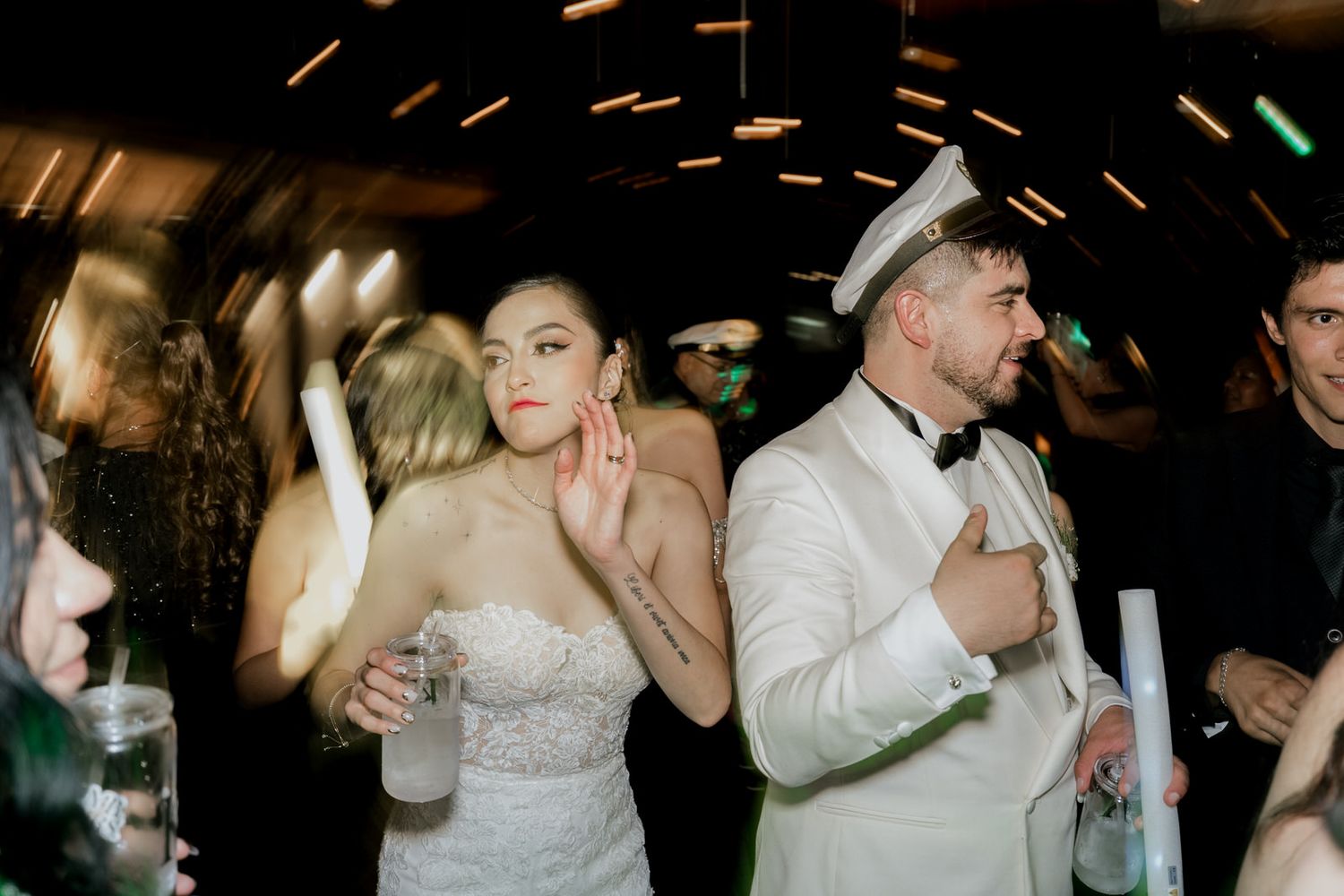 Lively dance floor scene with guests celebrating at wedding reception.