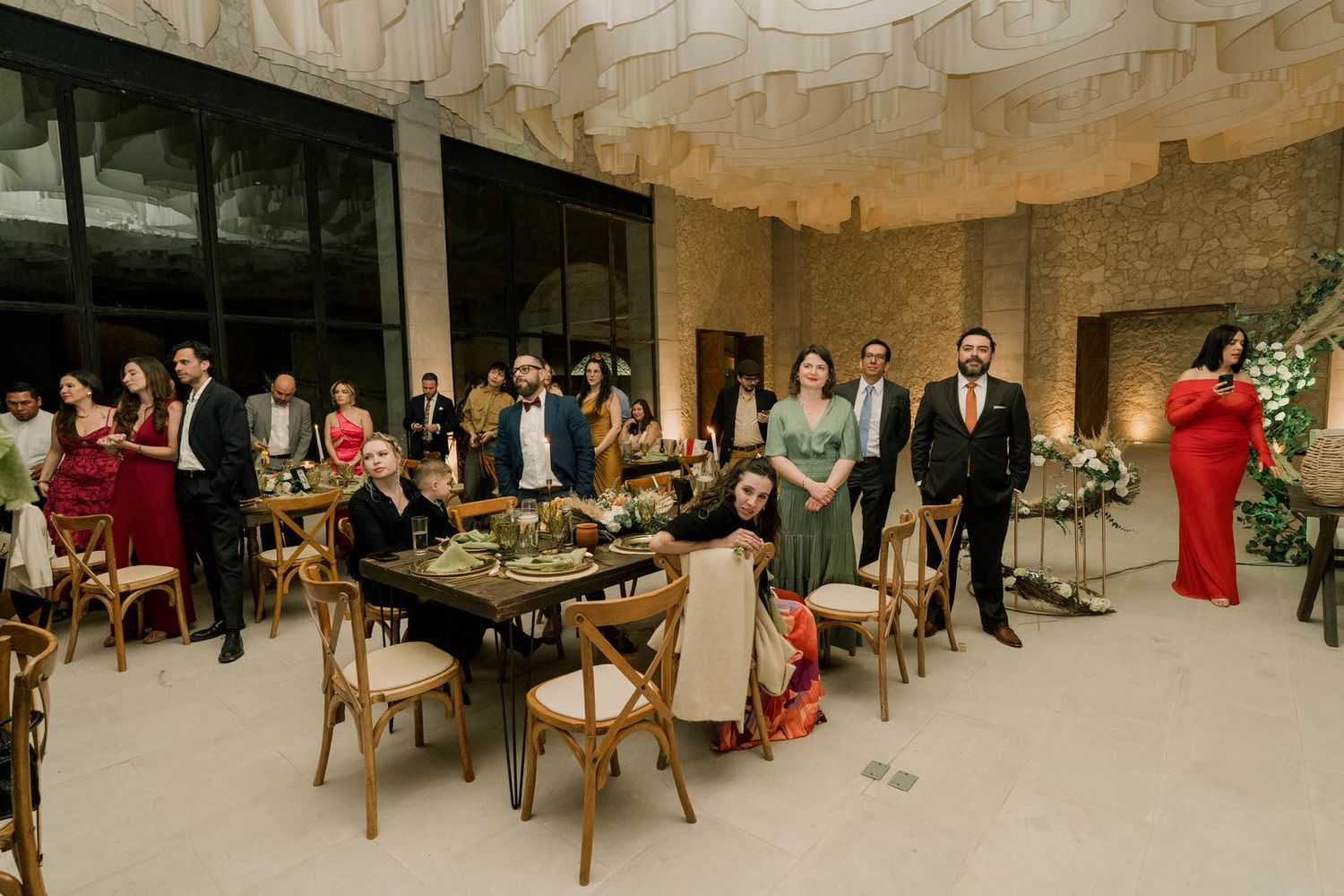 Wedding reception panorama showing elegant table settings and guests in formal attire.