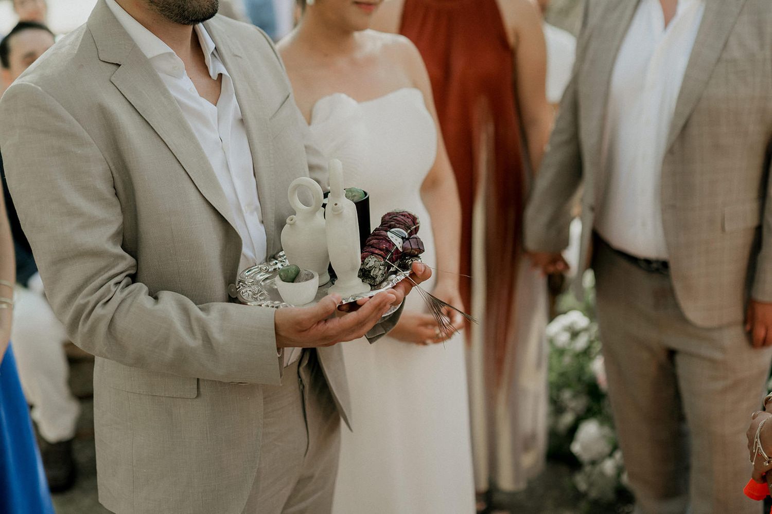 Elegant outdoor wedding ceremony setup with white draping and natural greenery.