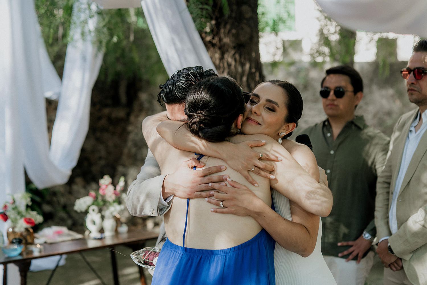 A collage of romantic wedding moments showing couples embracing and dancing during an outdoor celebration.
