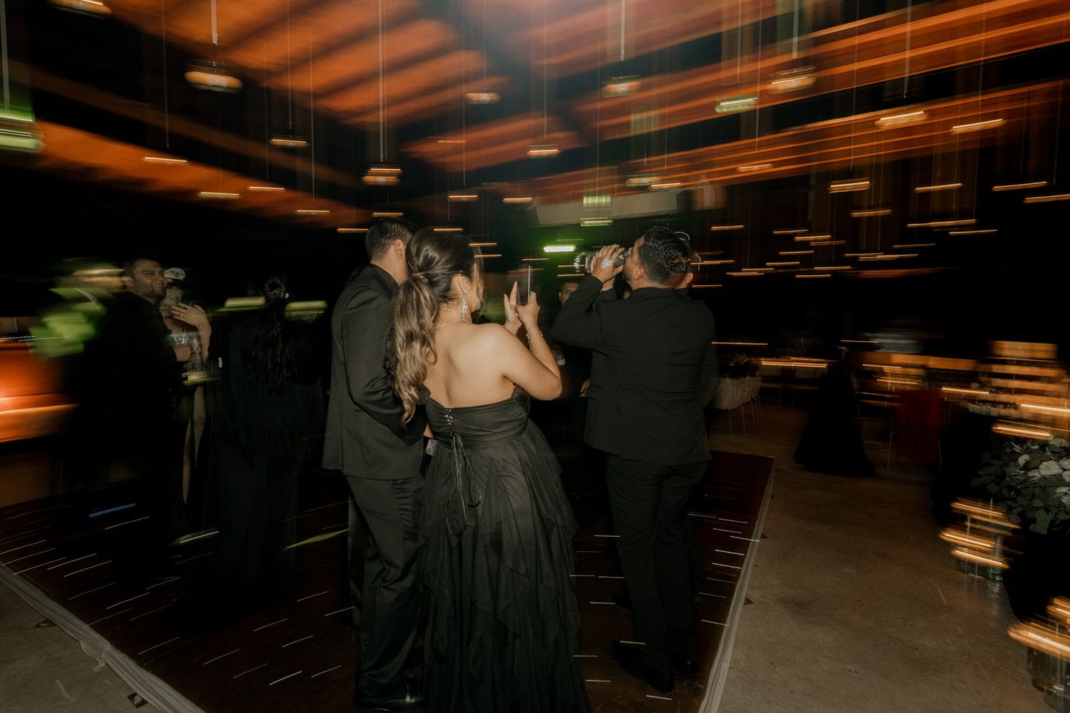 Dark reception venue with dramatic lighting and motion blur effects.