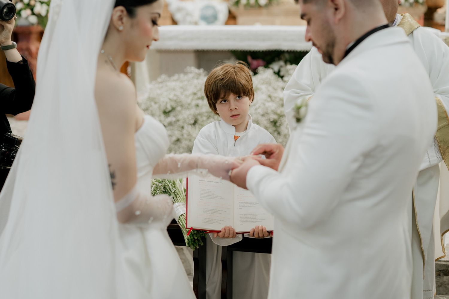 A couple exchanges rings during an intimate wedding ceremony moment.