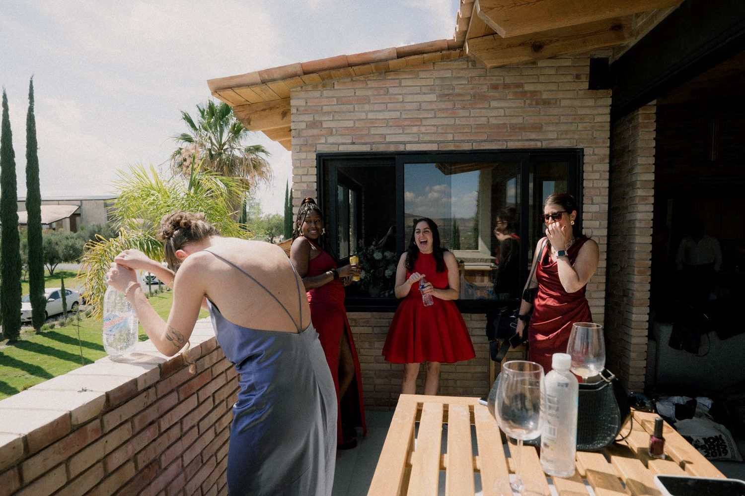 Outdoor venue with mountain views and brick architecture visible in background.