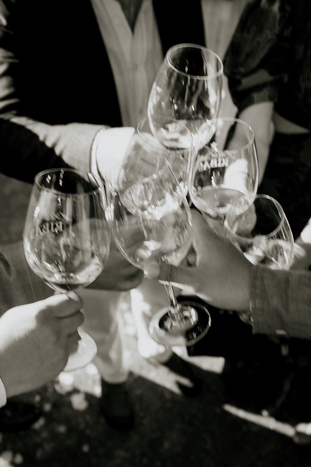 Black and white image of wine glasses on a formal dining table.
