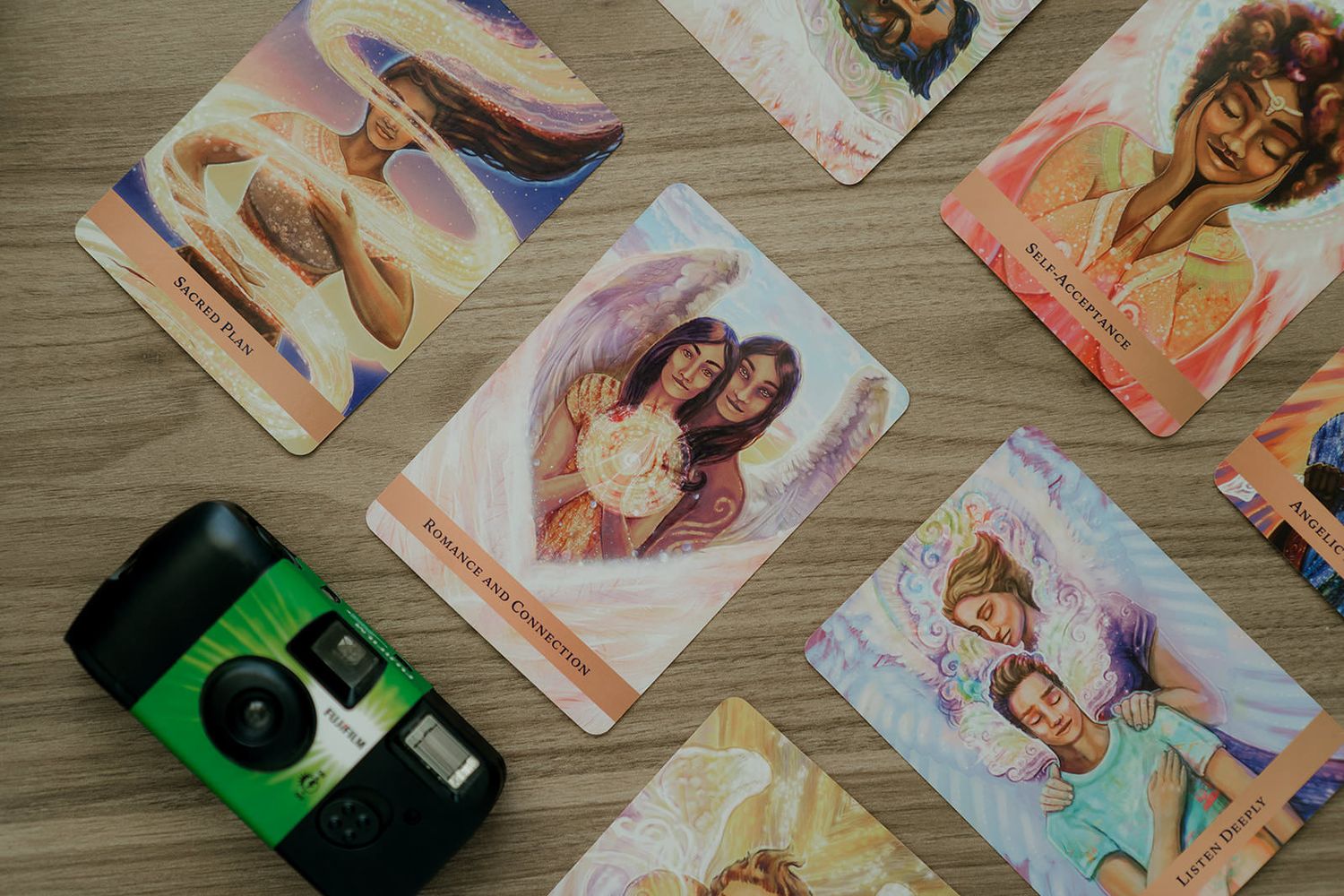 A collection of vintage Polaroid photographs scattered across a wooden surface in warm lighting.