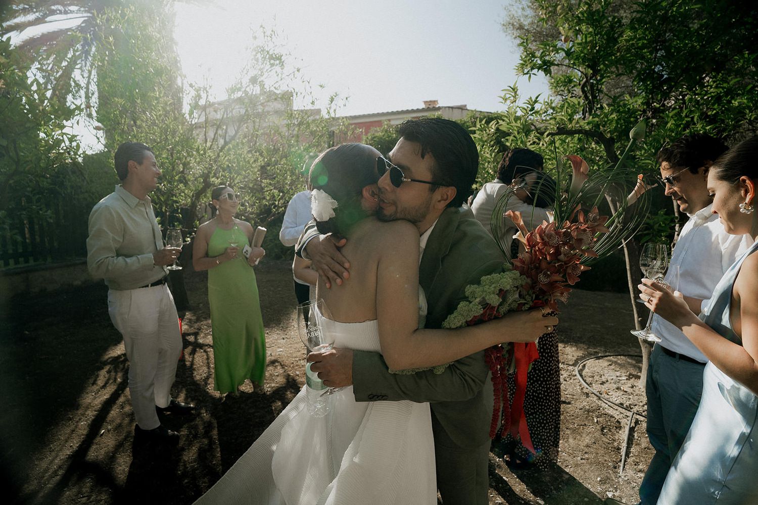 A series of candid outdoor party photos showing guests mingling and socializing at a garden gathering.