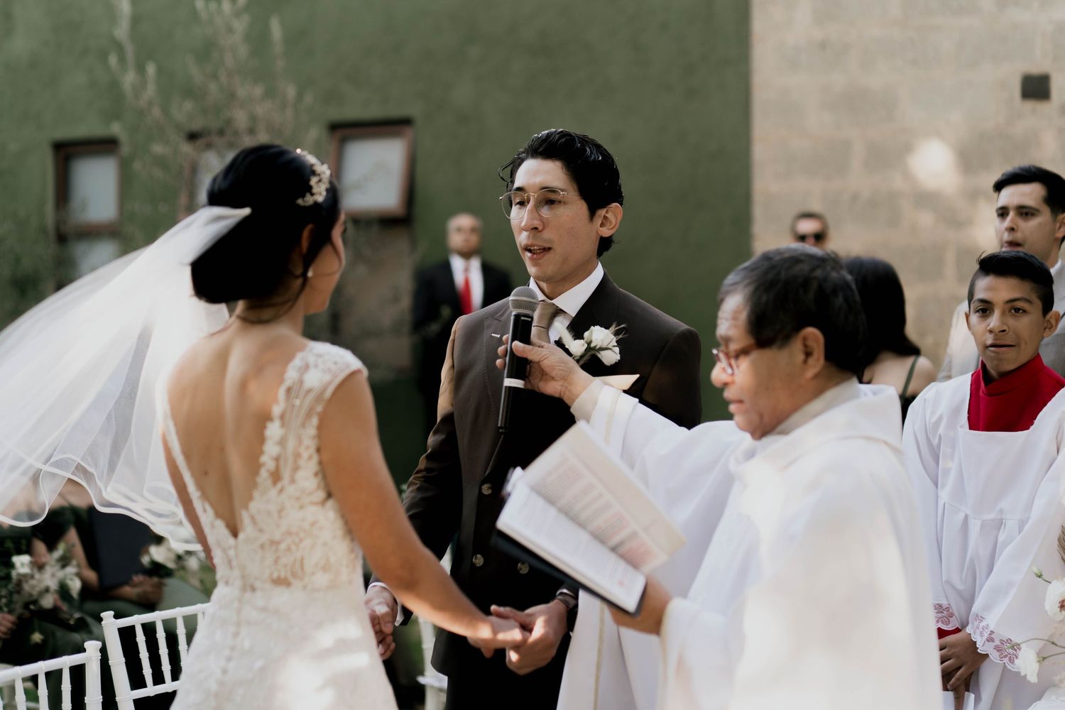 Wedding party members gathered during an outdoor celebration with white decor.