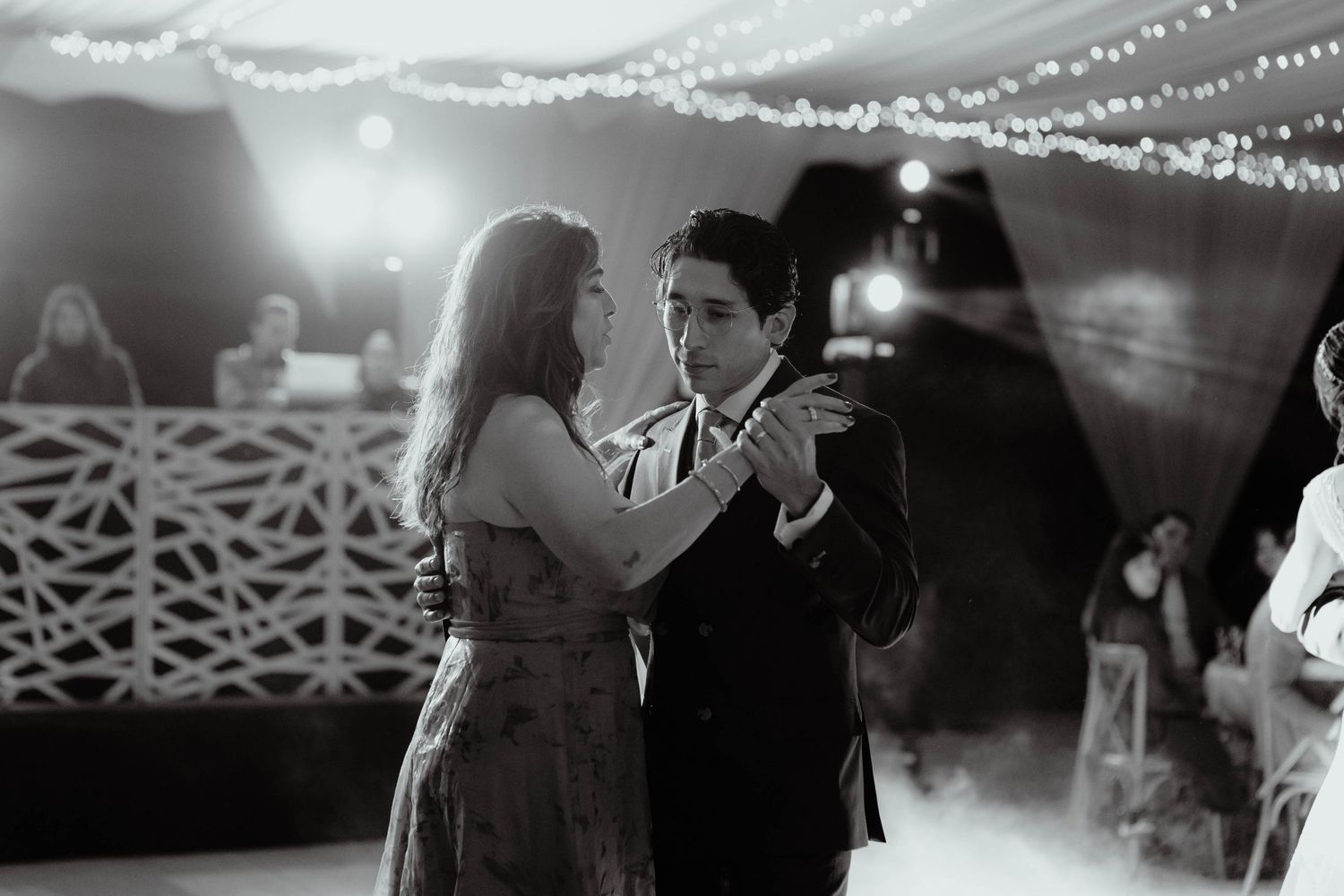 Wedding reception dance floor with twinkle lights and decorative ceiling details.