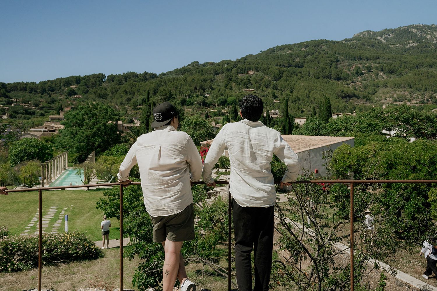 Rolling hills and mountains with traditional Mediterranean buildings nestled in the landscape.