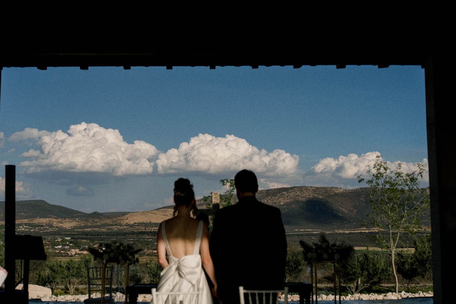 Scenic mountain landscape view from wedding venue with blue sky and white clouds.