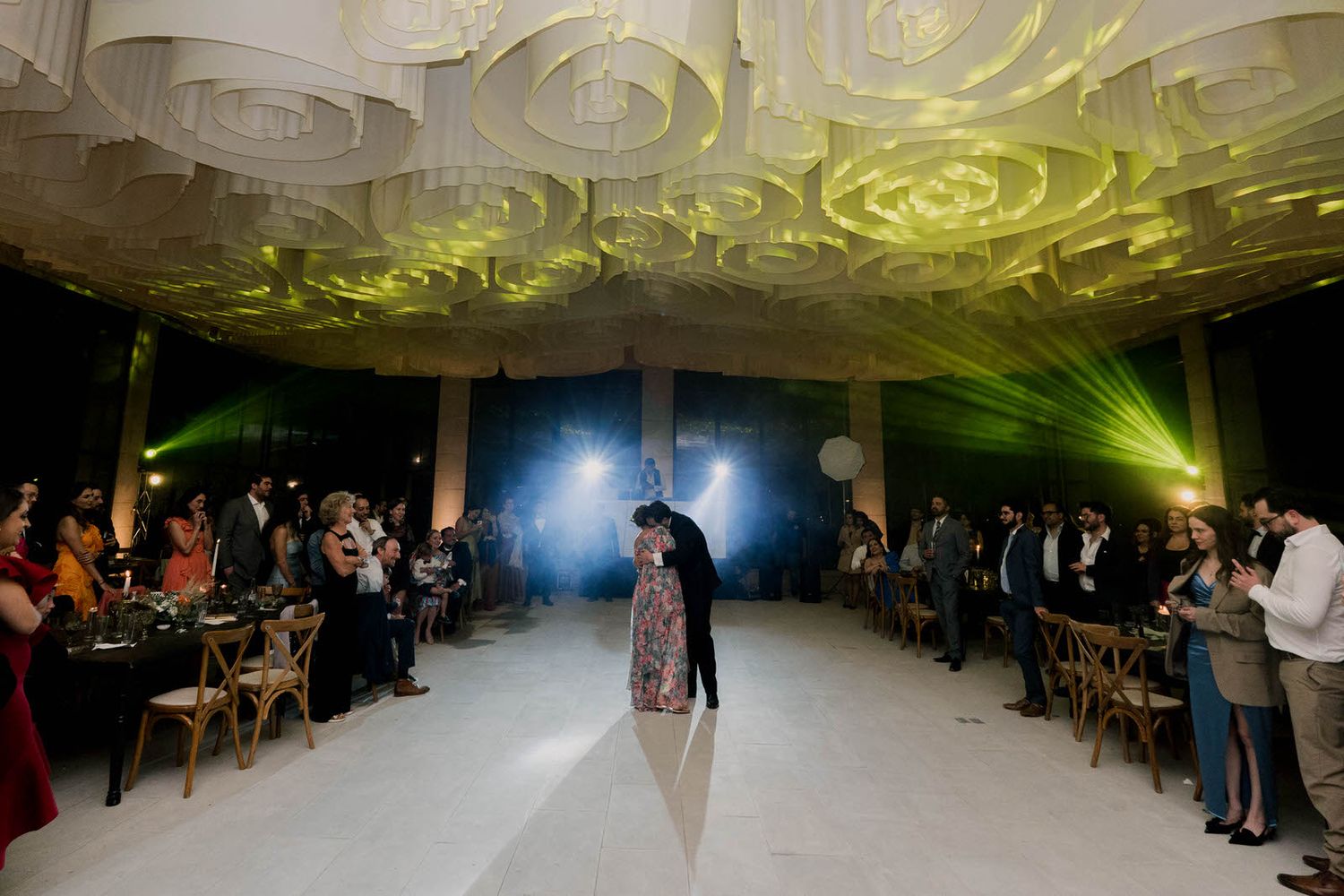 Wide angle shot of a wedding reception dance floor with dramatic lighting effects.