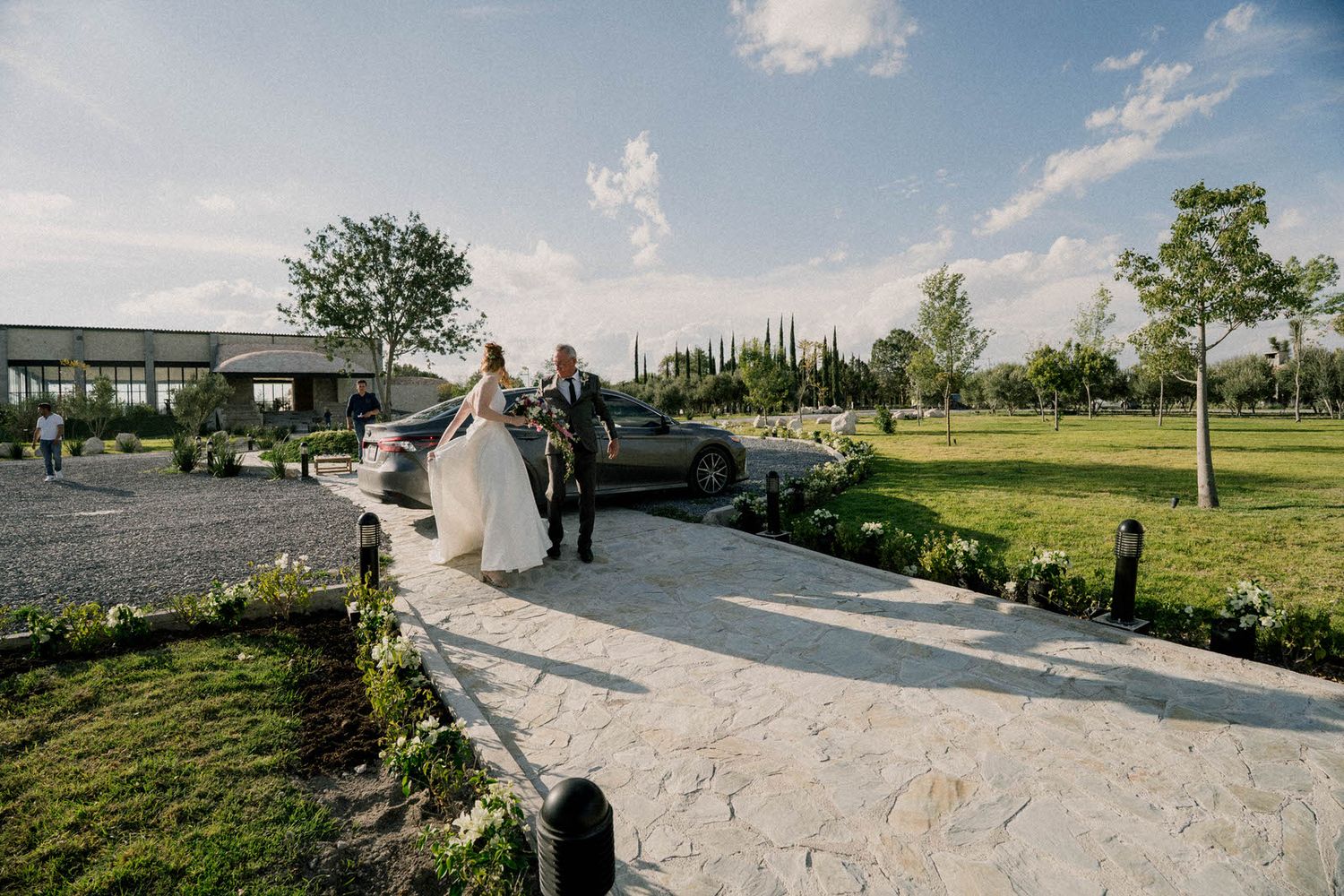Panoramic view of outdoor wedding venue with stone pathways and mountain landscape.
