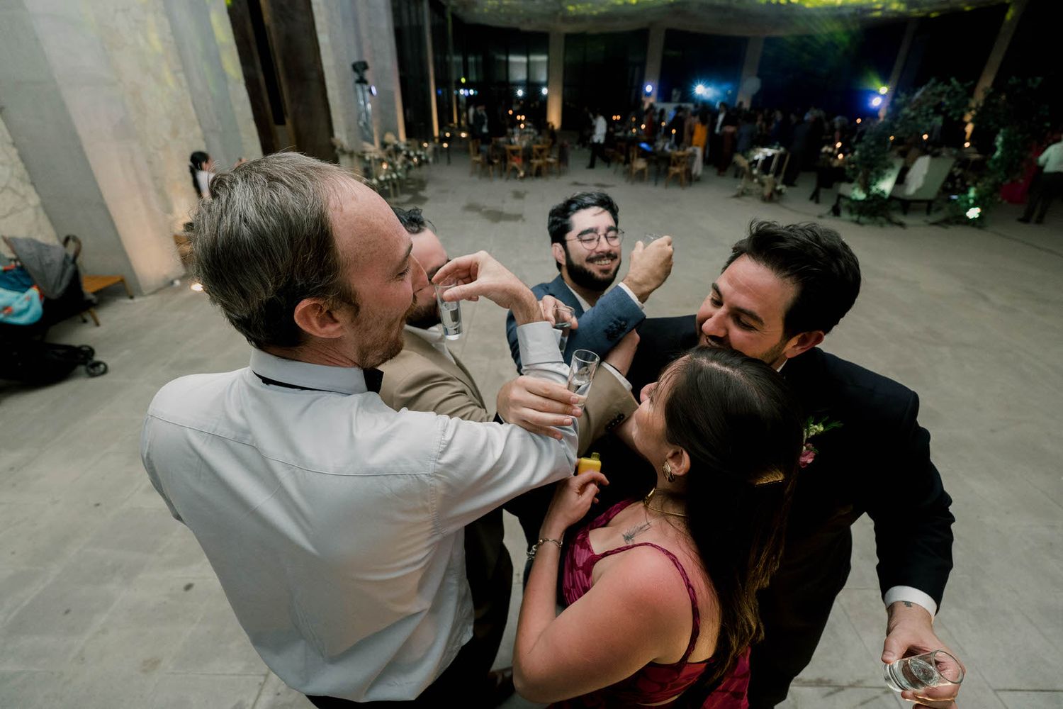 Guests at a celebration share a playful moment during a lively party.