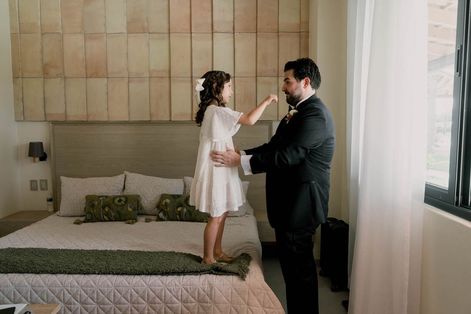 A series of candid moments captured in a modern bedroom with natural lighting.