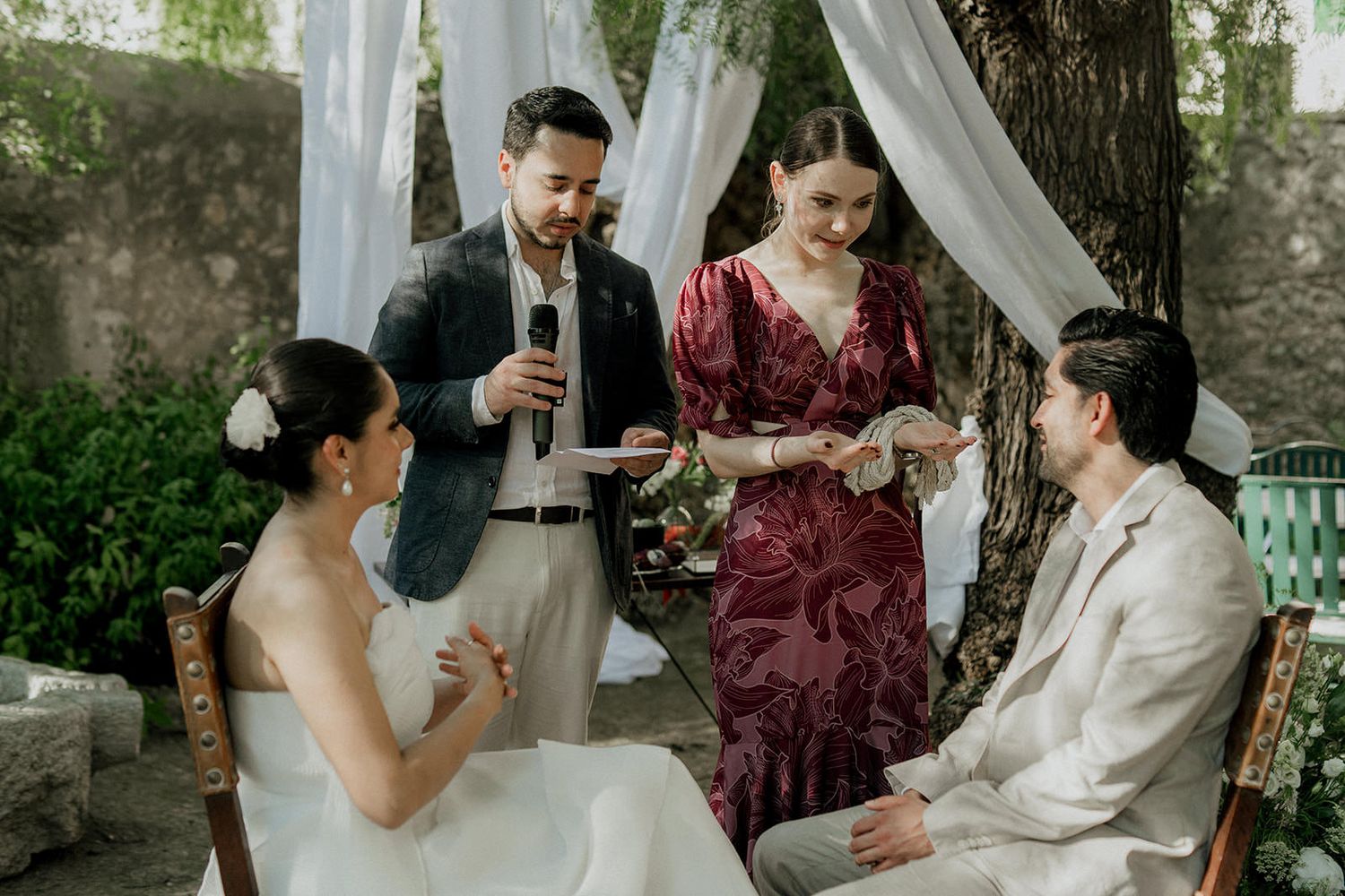 Wedding party celebrates with champagne toasts in a garden setting.