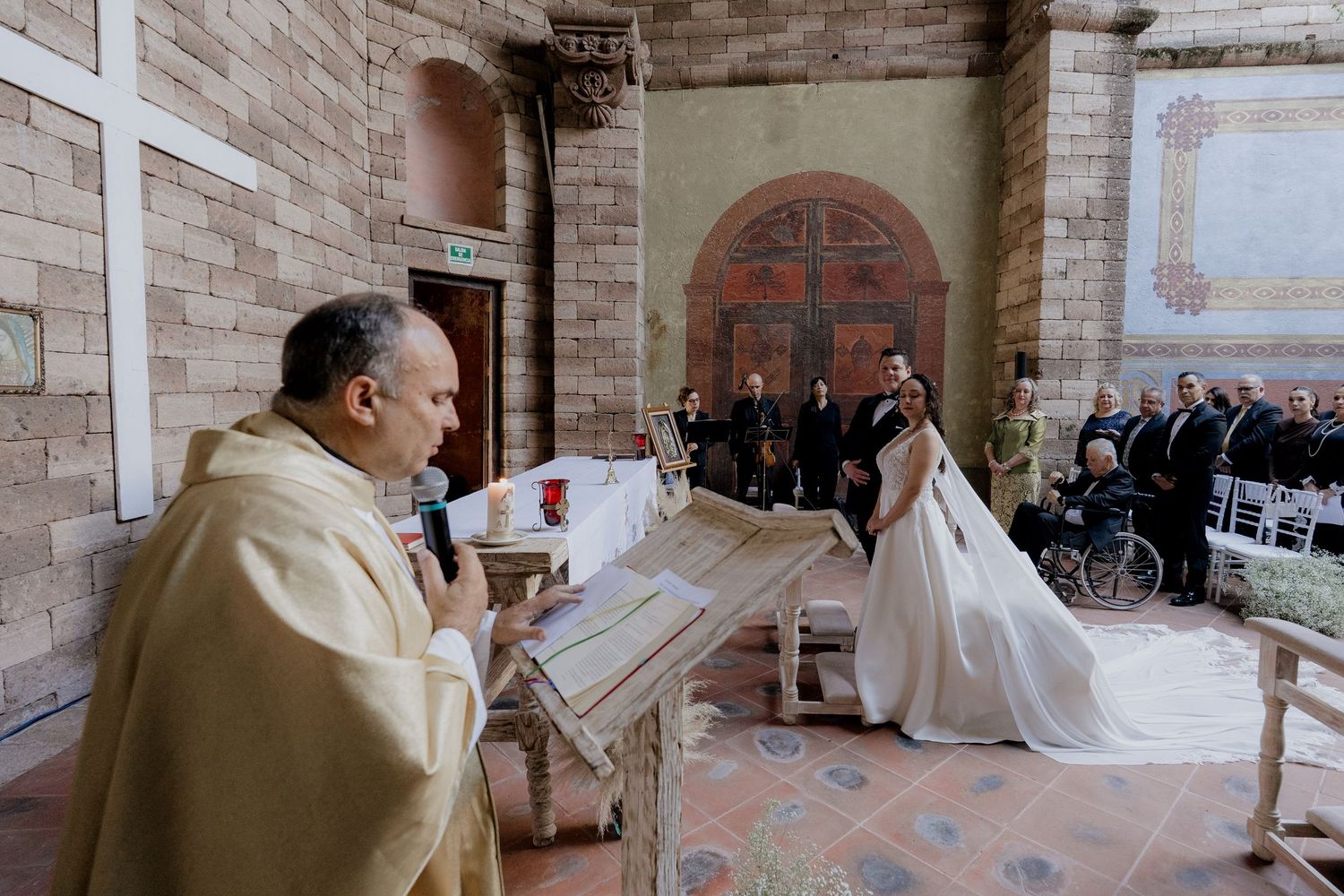 Interior shots of a church wedding ceremony with stone architecture and arched windows.