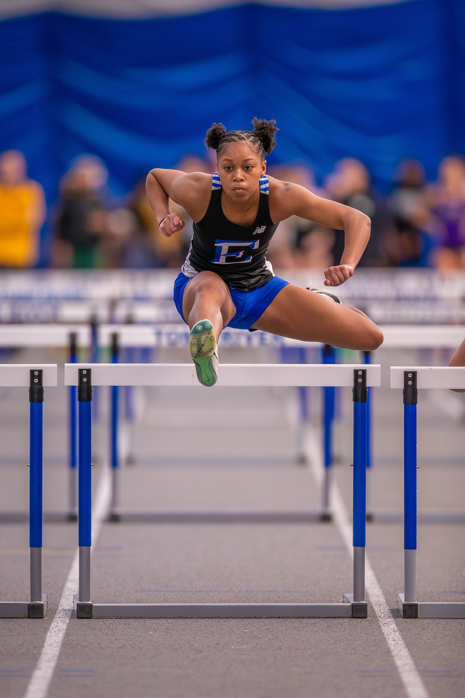 Ewing High School track athlete racing hurdles in Ocean County, New Jersey.
