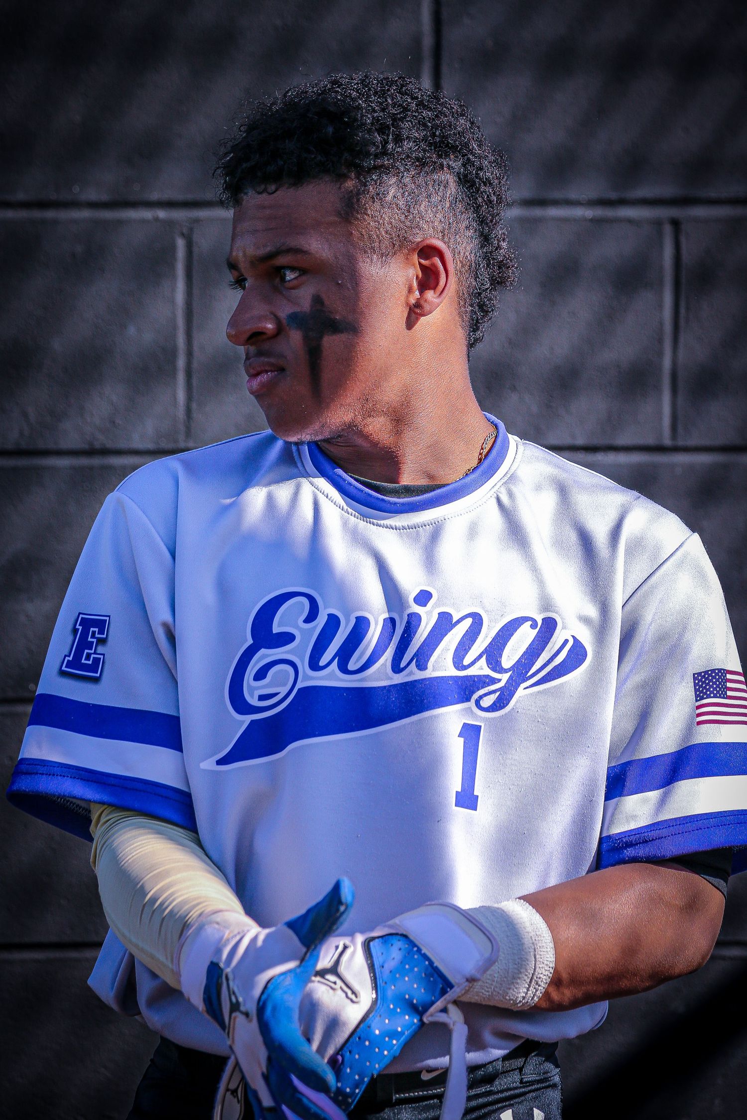 Ewing High School varsity baseball player posing in dugout in Mercer County, New Jersey.