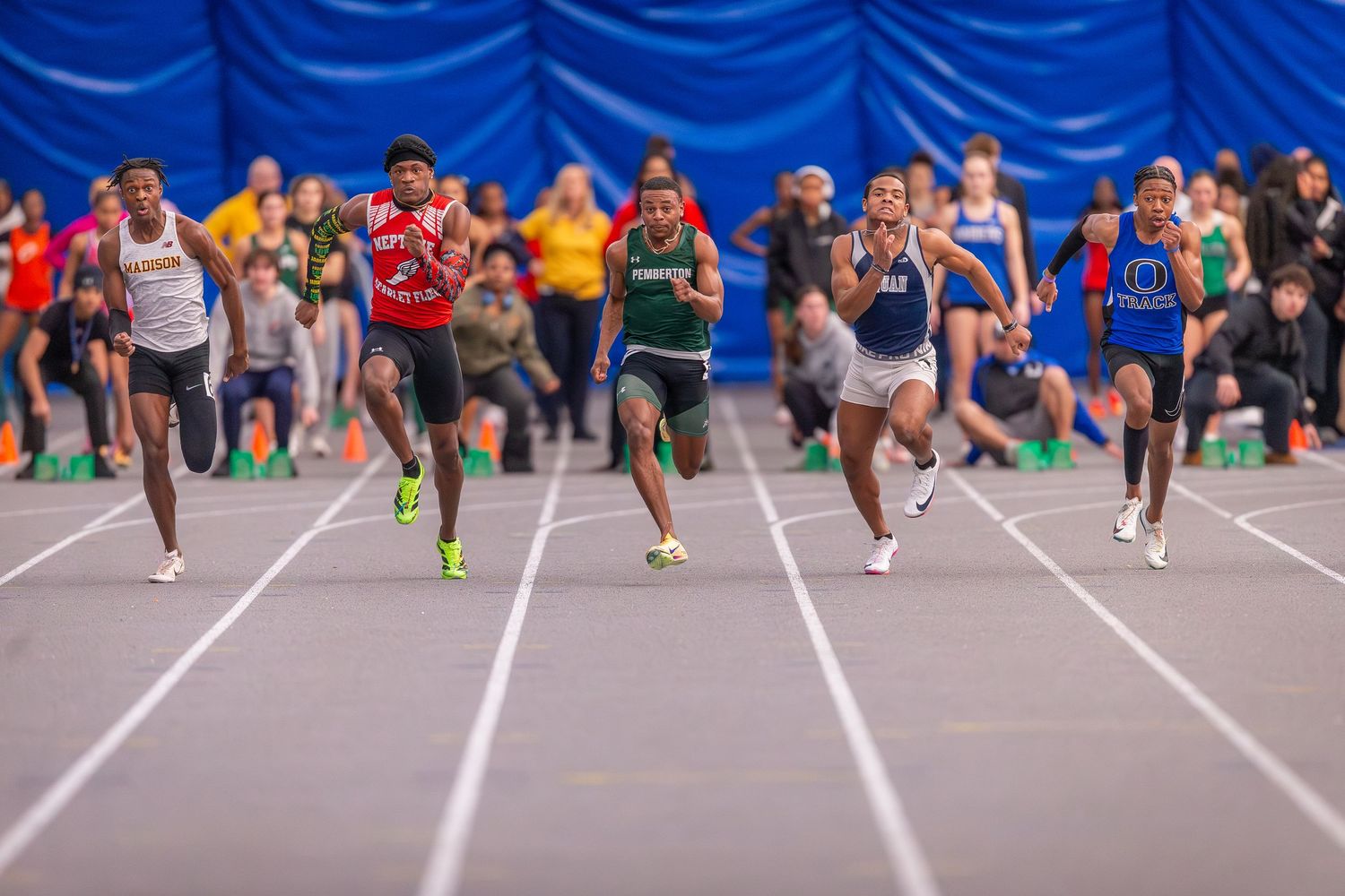 Multiple track atheletes competing in a running race in Ocean County, New Jersey.