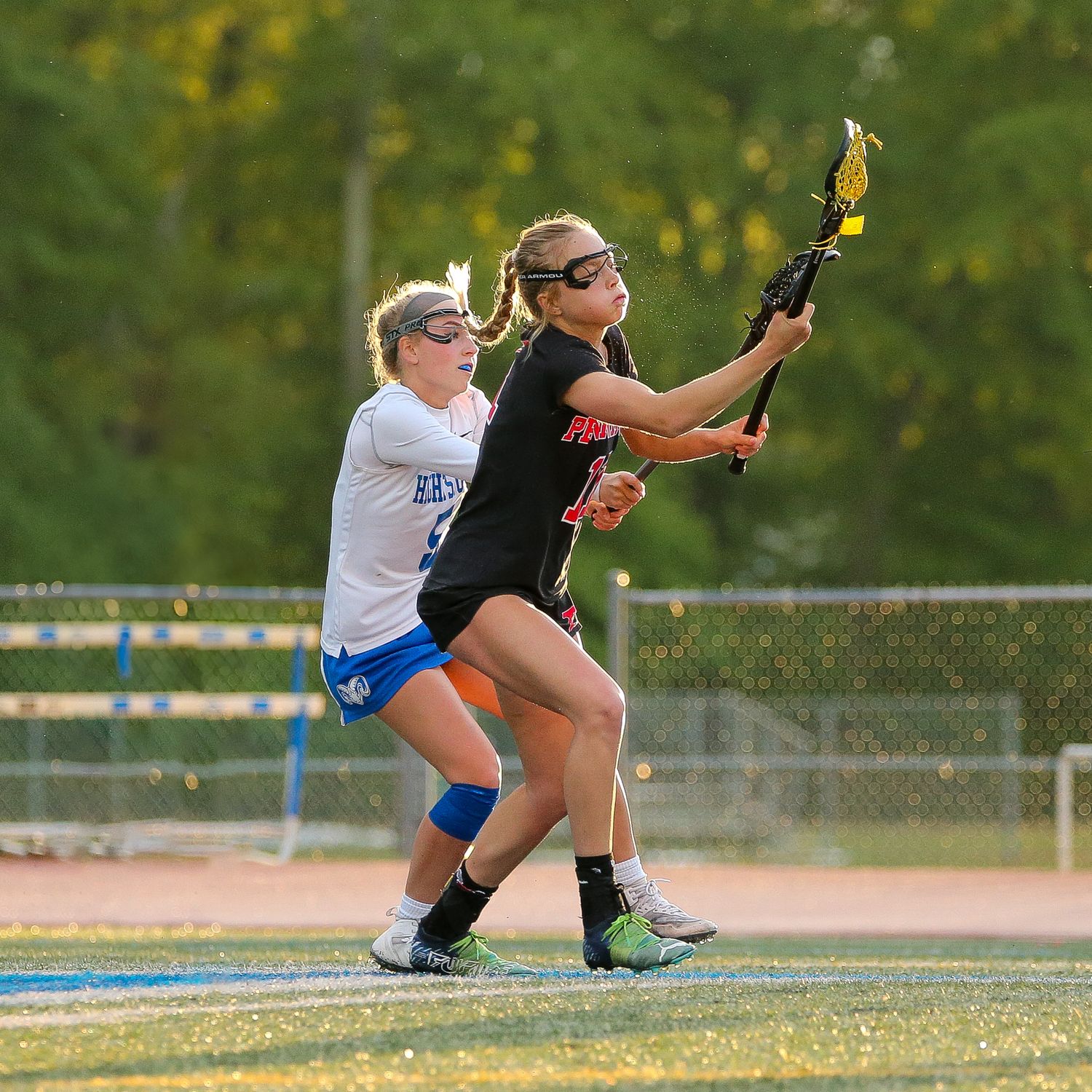 Robbinsville High School and Hightstown High School girls lacrosse players fighthing for the ball in Mercer County, New Jersey.