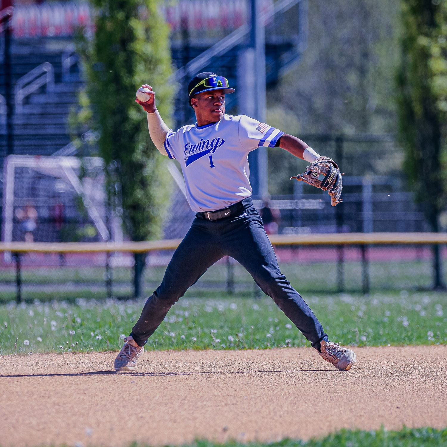 Ewing High School varsity baseball player throwing the ball in Mercer County, New Jersey.