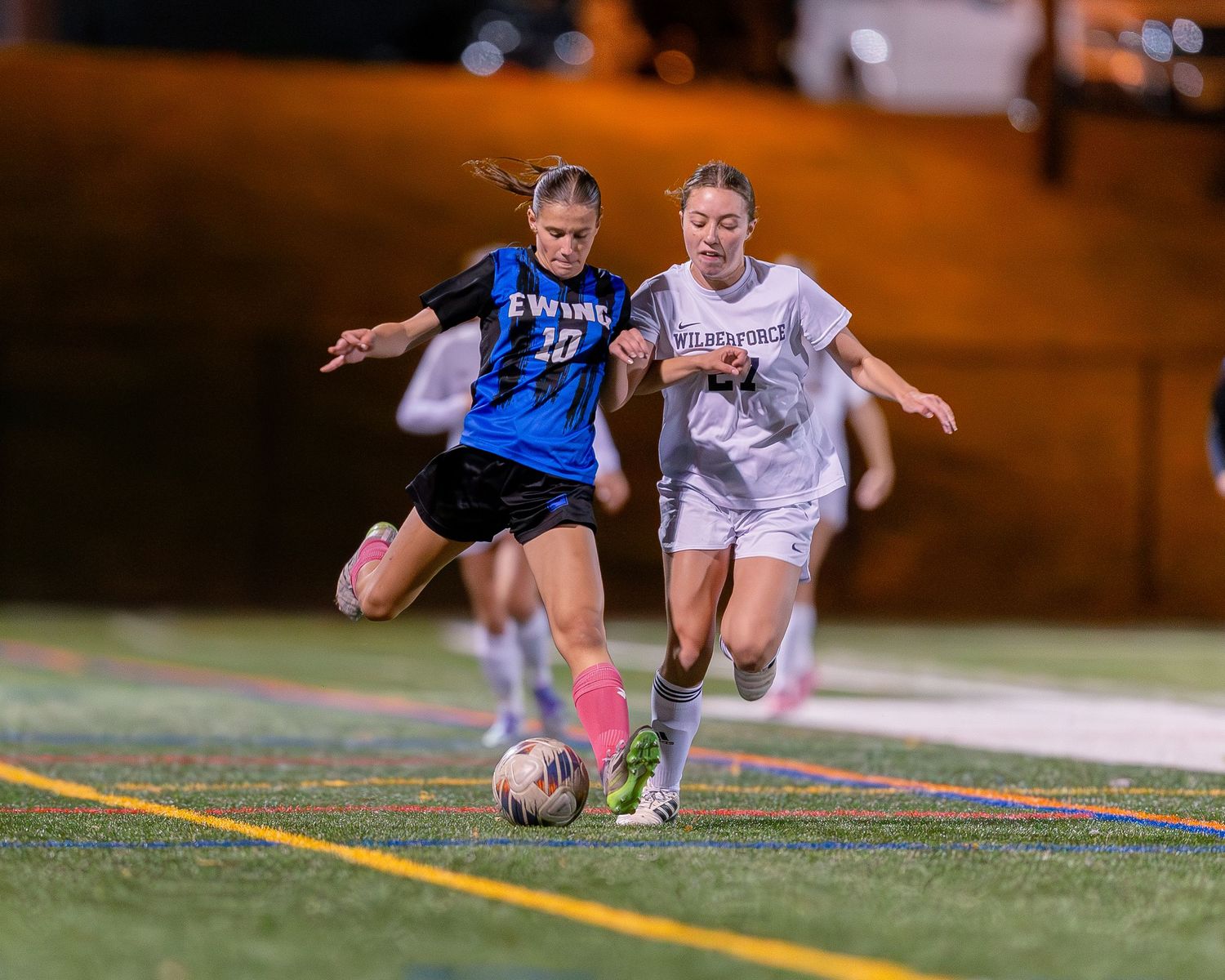 Ewing High School girls varsity soccer player kicking the ball in Mercer County, New Jersey.