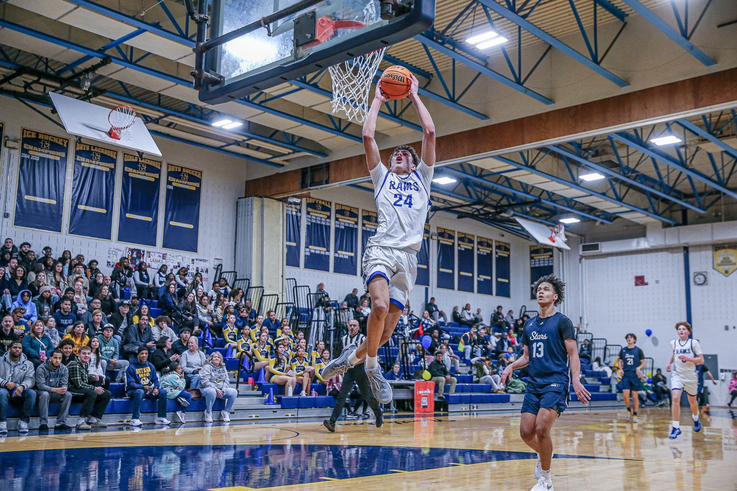 Hightstown High School basketball player dunking the ball at Nottingham High School in Mercer County, New Jersey.