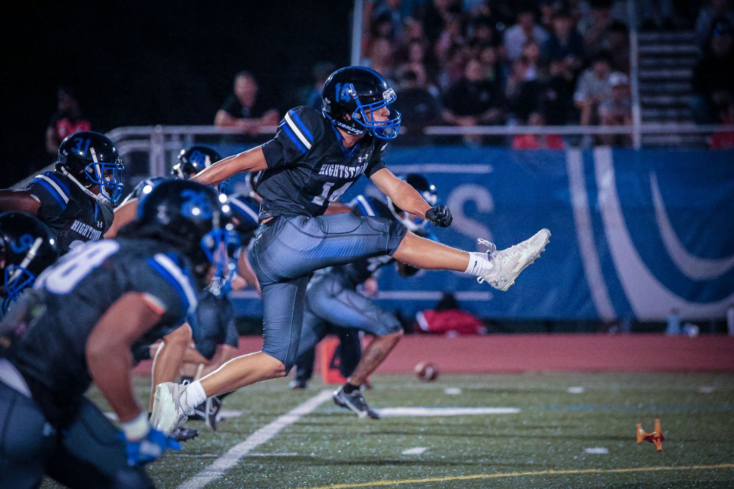 Hightstown High School varsity football player kicking the ball in Mercer County, New Jersey.