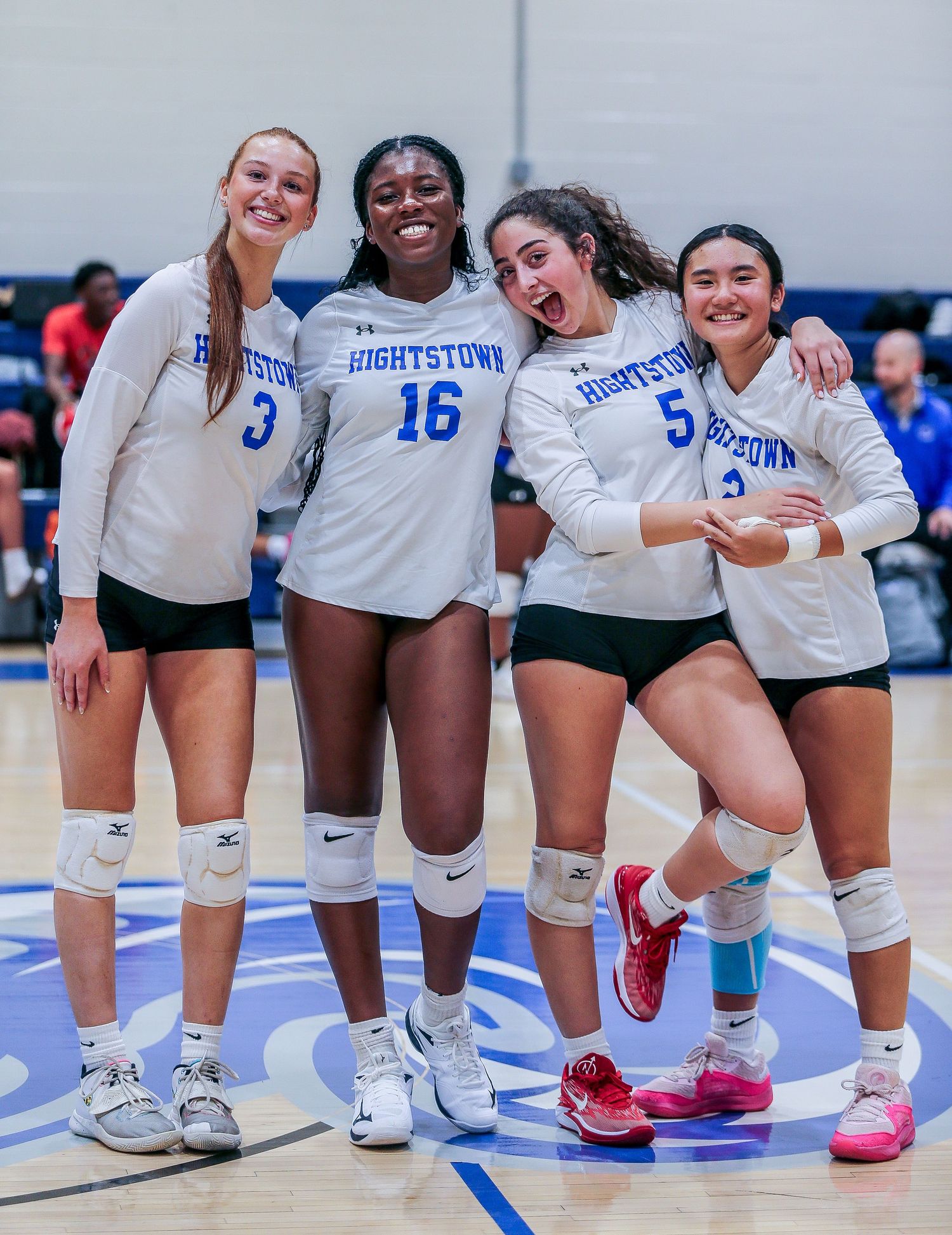 Hightstown High School varsity volleyball players smiling posing in Mercer County, New Jersey.