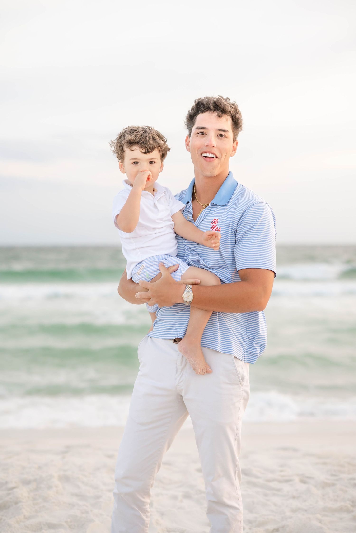 Family sharing joyful moments together on a bright sandy beach.