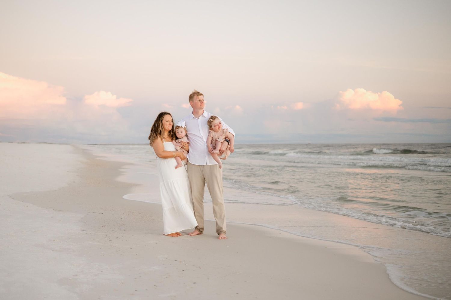 Family enjoying tender moments during sunset beach photography session.