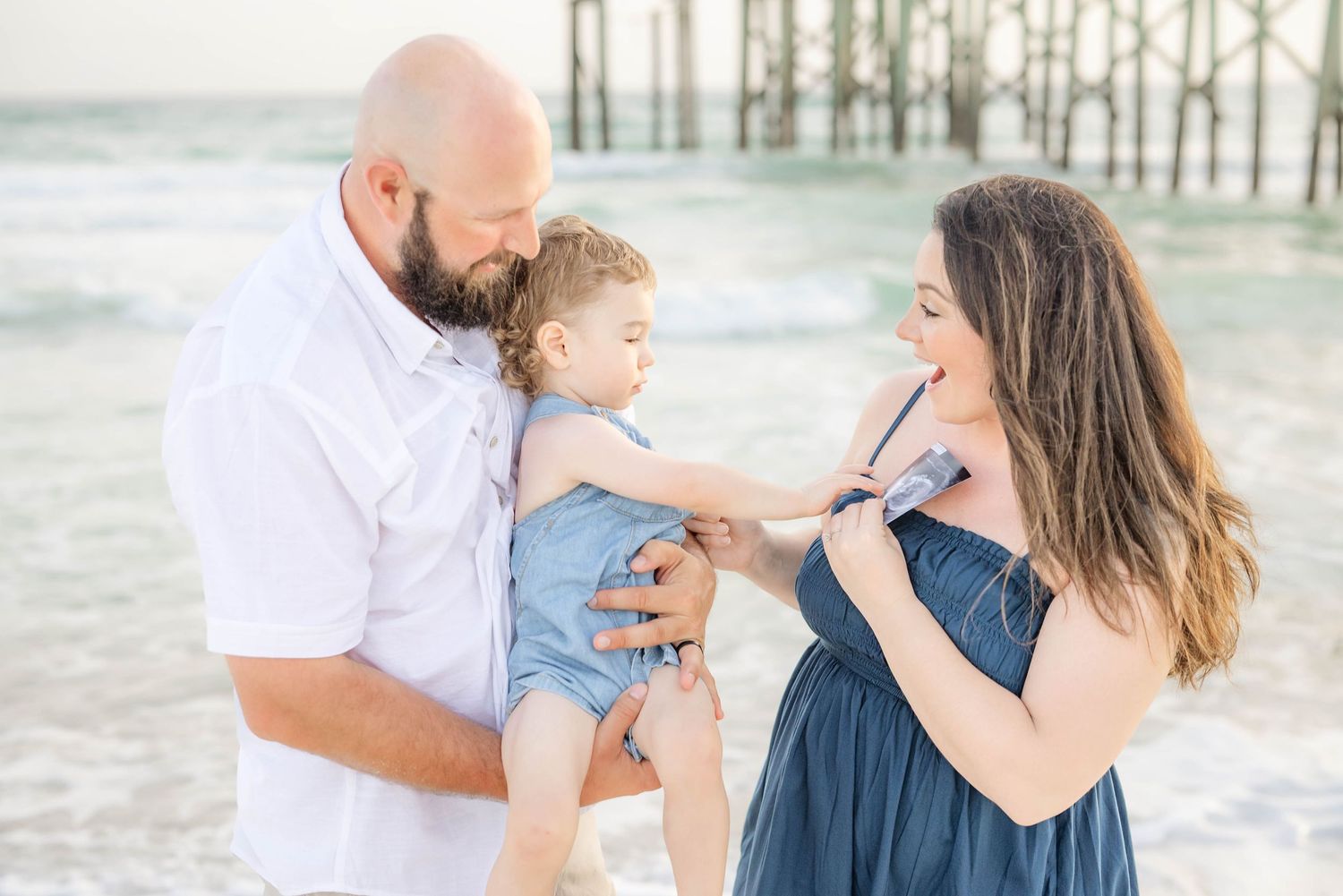 Candid family moments captured during a beachside photo session.