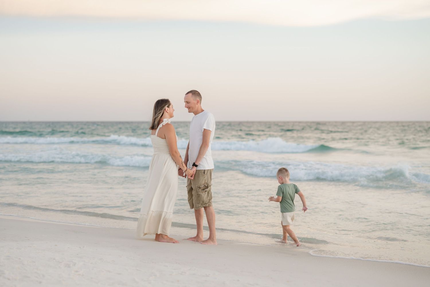 Sunset beach photoshoot with family enjoying time near the water.