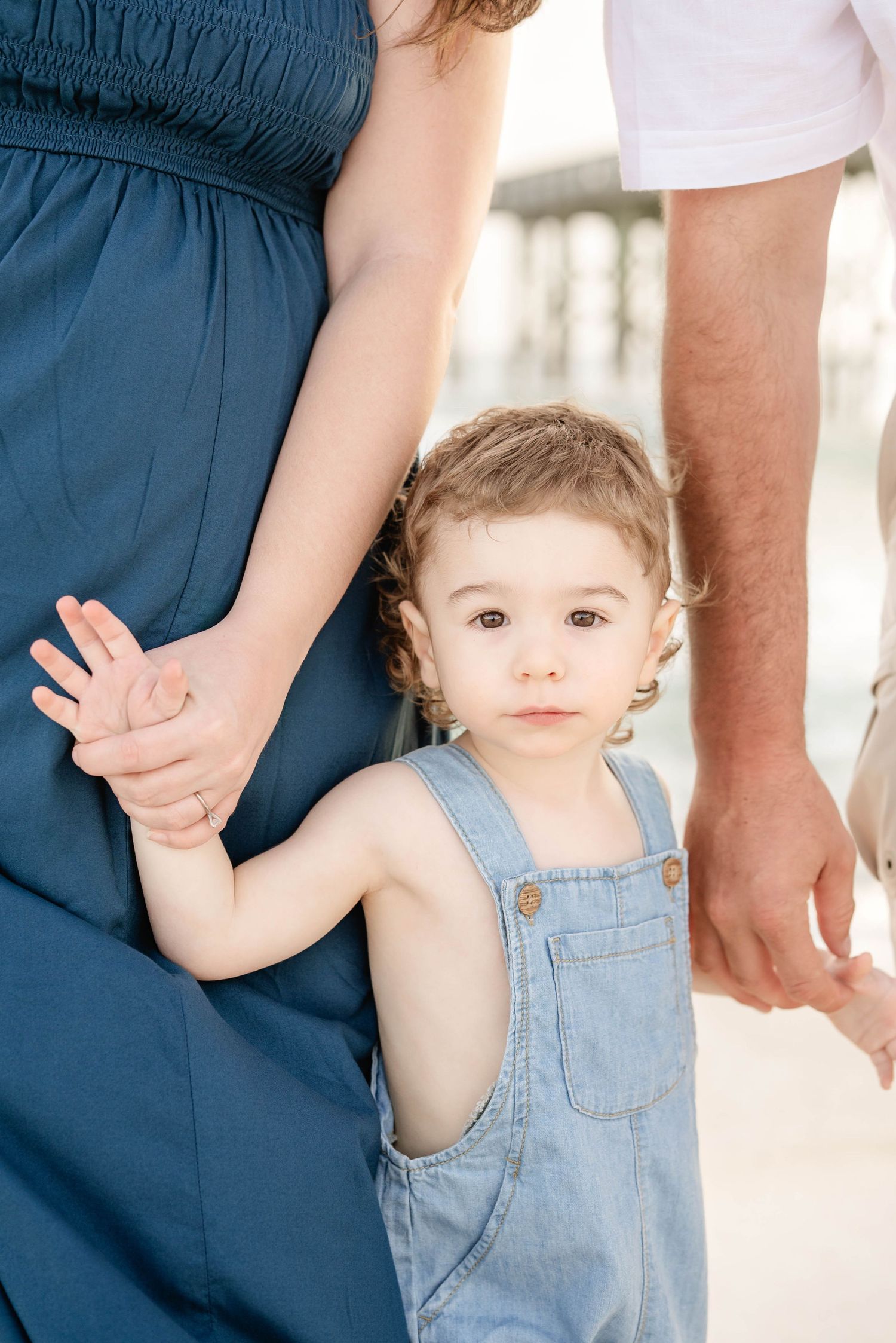 A collection of candid moments showing small hands holding onto adults in casual attire.