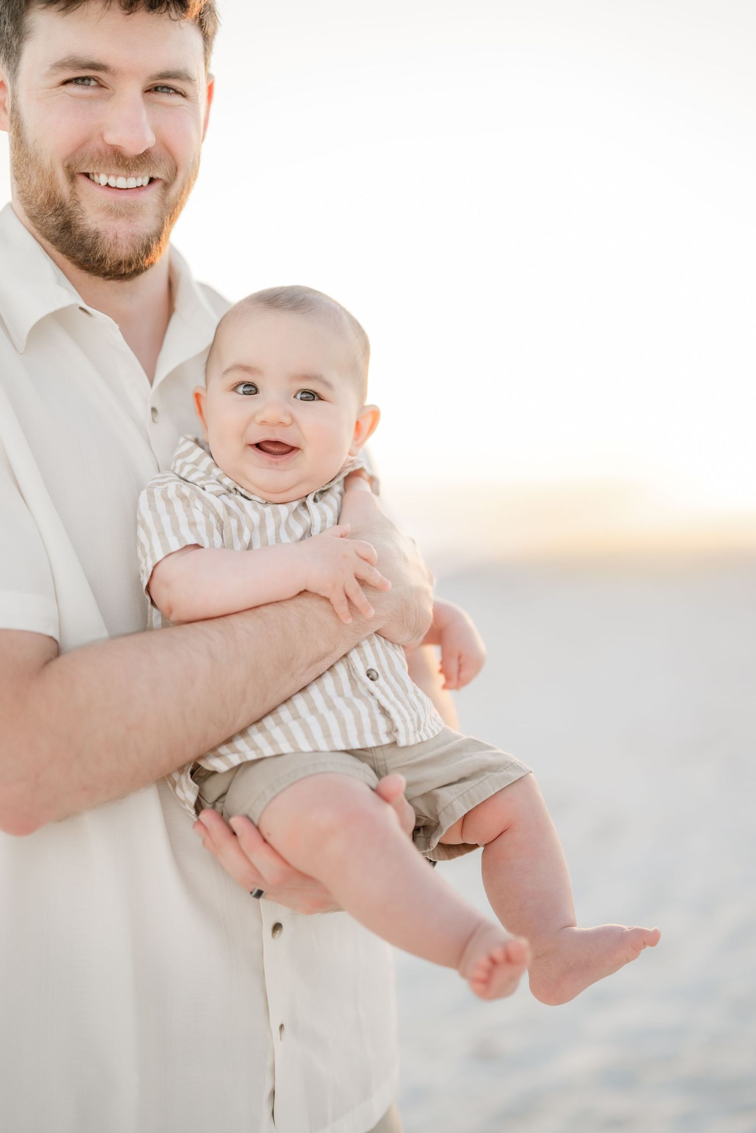 Happy moments captured during a bright beach family photoshoot.