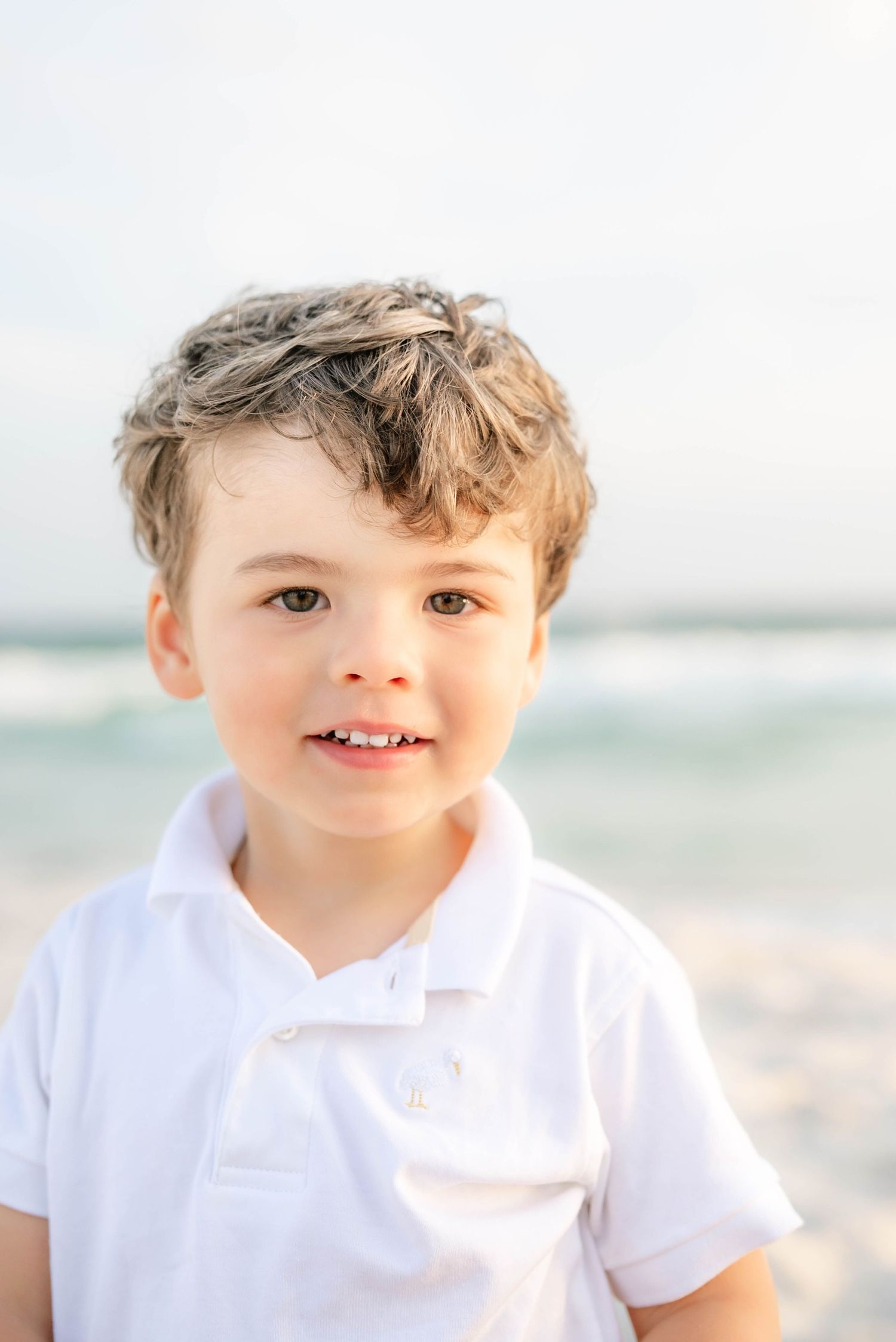 Close-up beach portraits with soft lighting and ocean background in Panama City Beach, Fl..