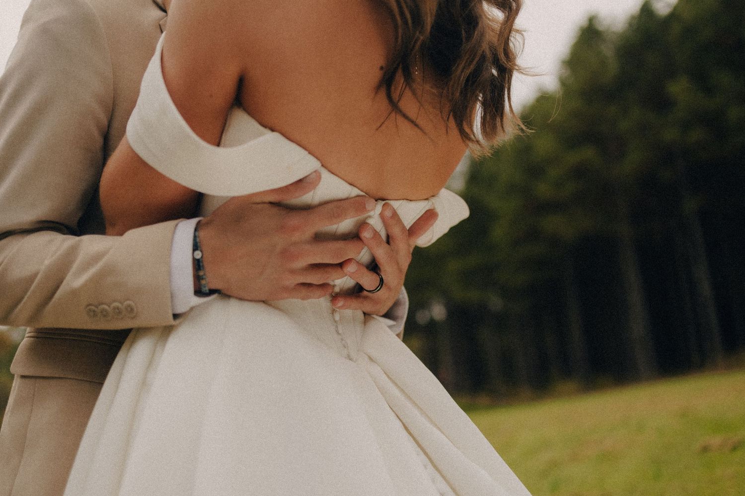Intimate wedding couple moment captured in outdoor setting.