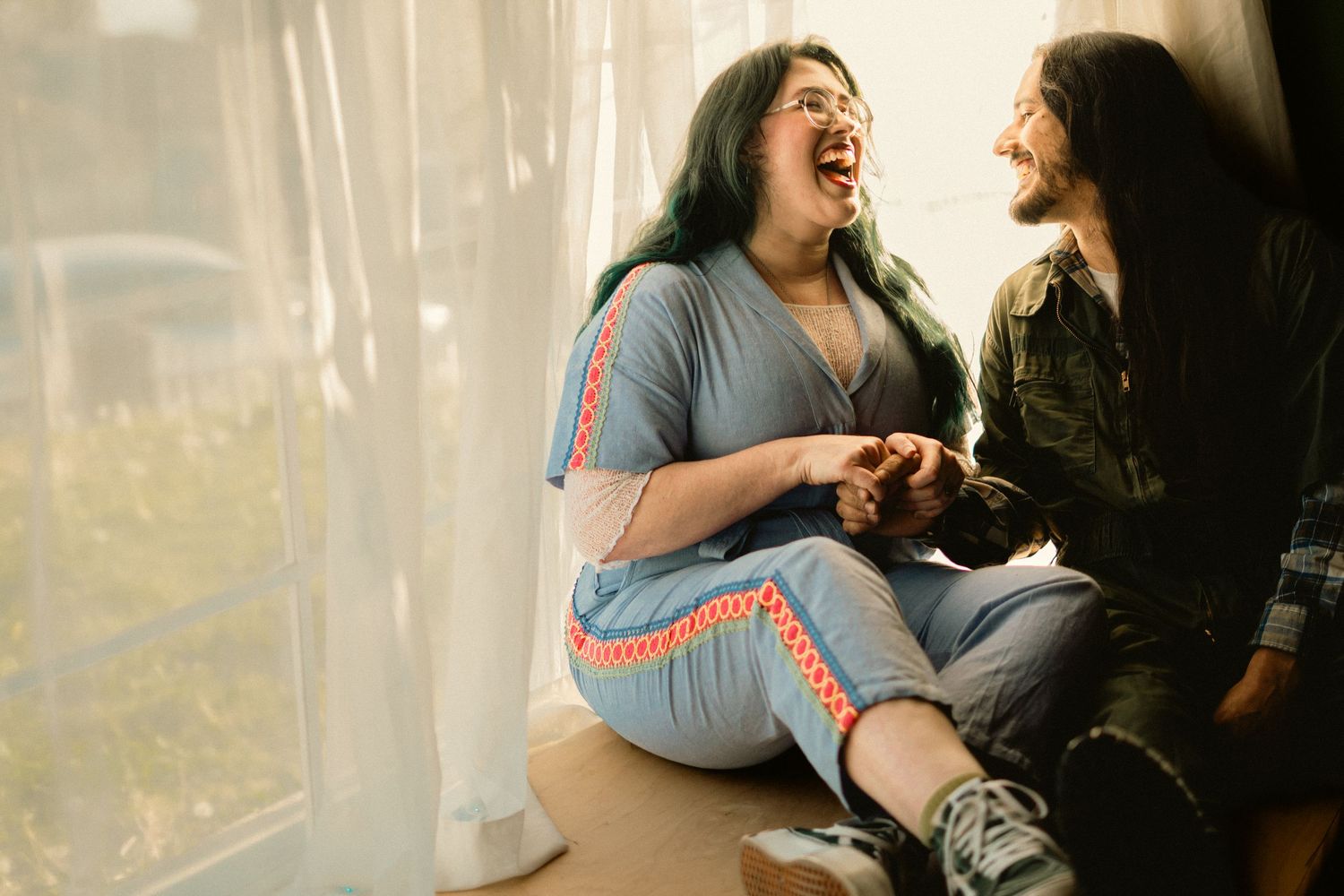 An engaged couple laugh in Bakersfield Ca