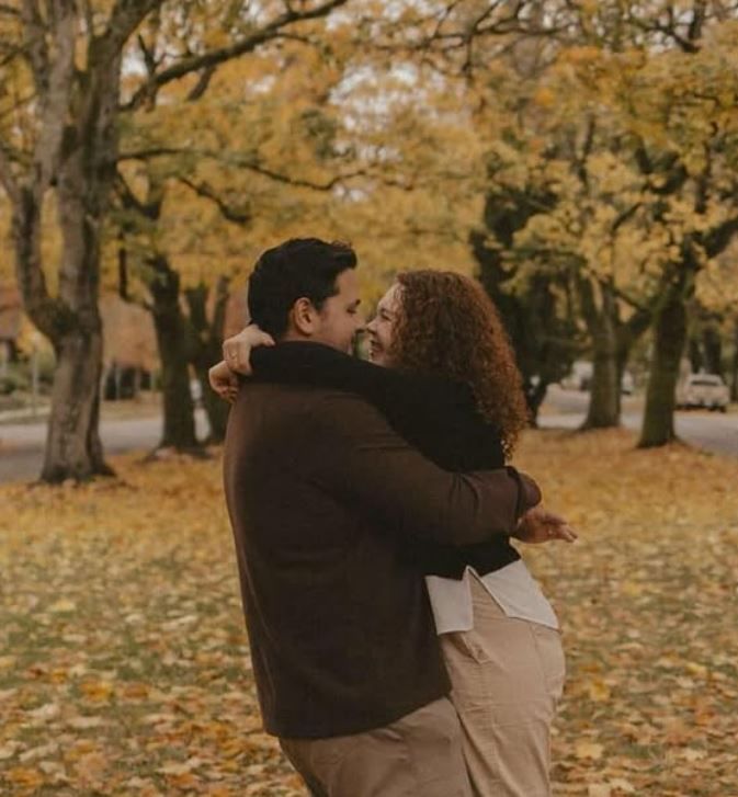 Erin Danae and Gabriel of Erin Danae Photos. Photo shows the team as a married couple spinning in front of trees