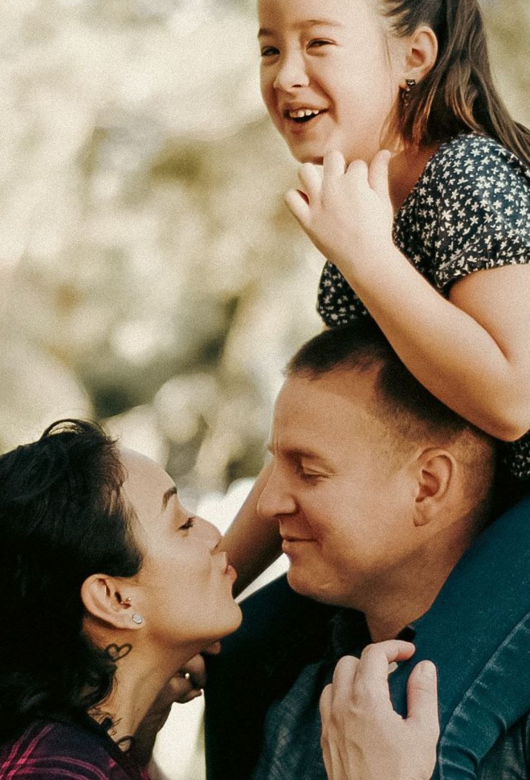 Couple poses with child