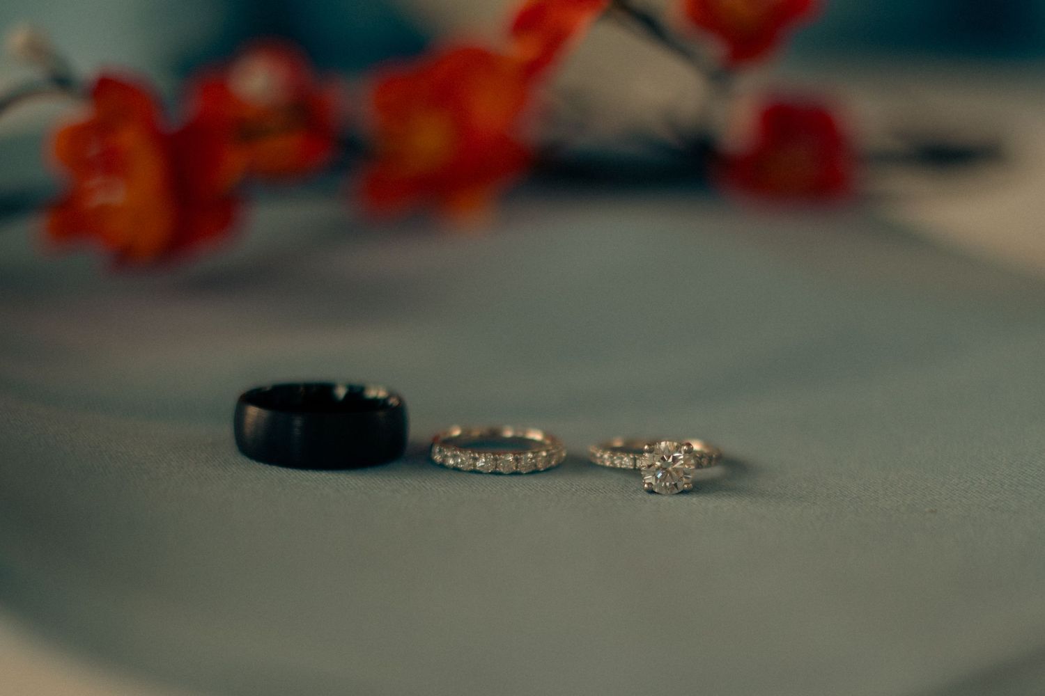 Three rings sit on a blue napkin. Wedding rings, and engagement ring at M ranch in Tulare California.
