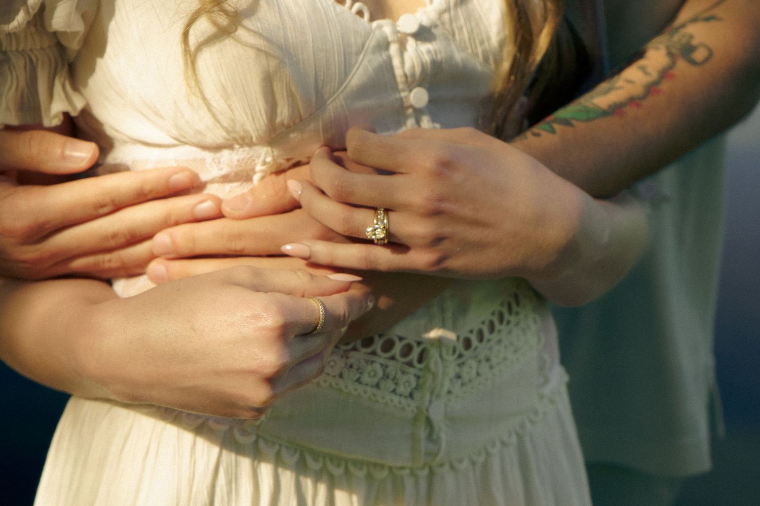 An engaged couple hold hands