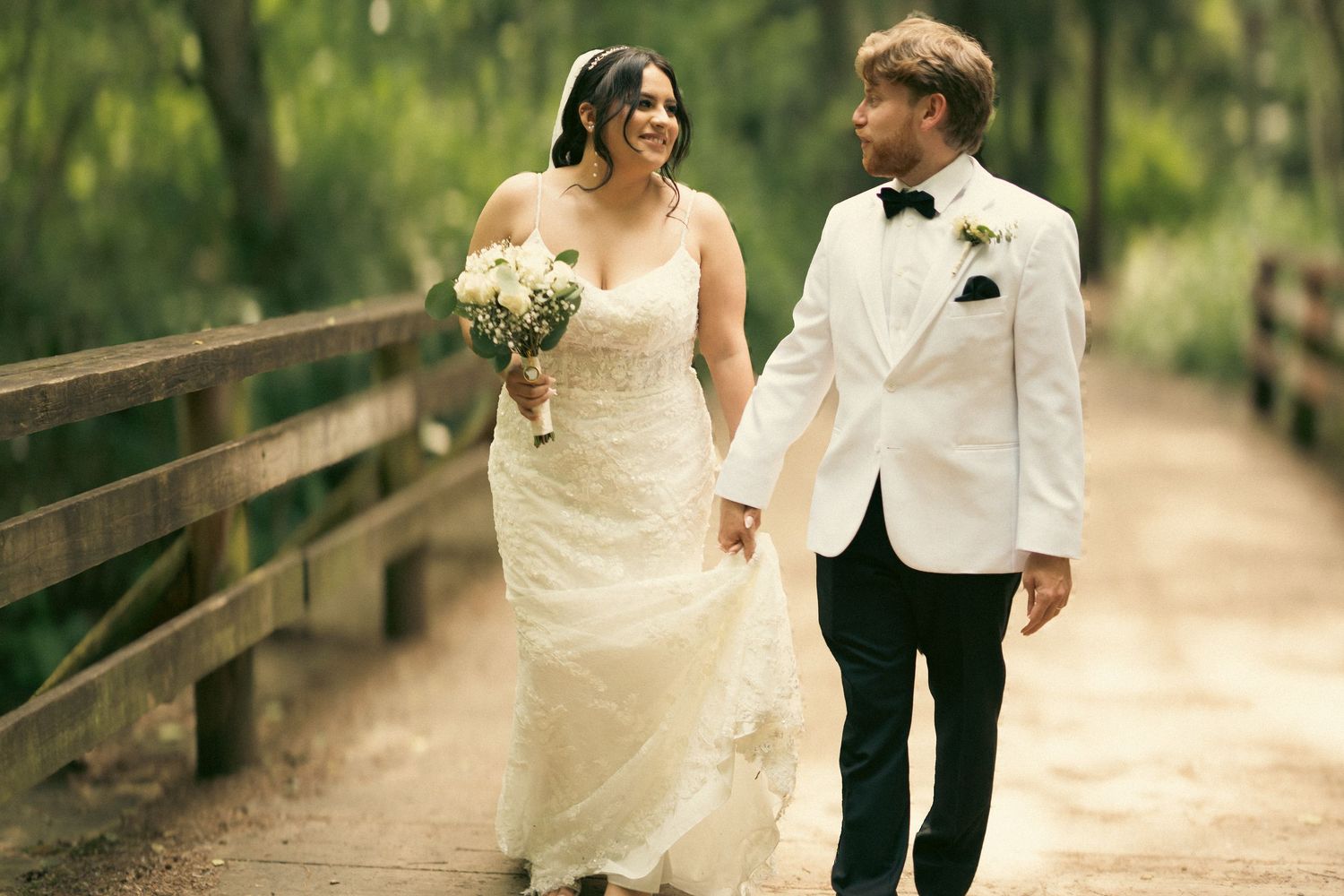Couple in greenery hold hands