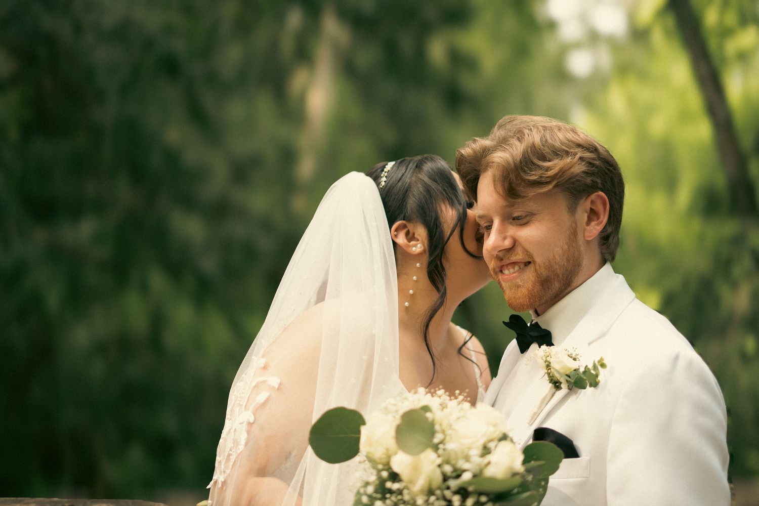 Couple in greenery whisper