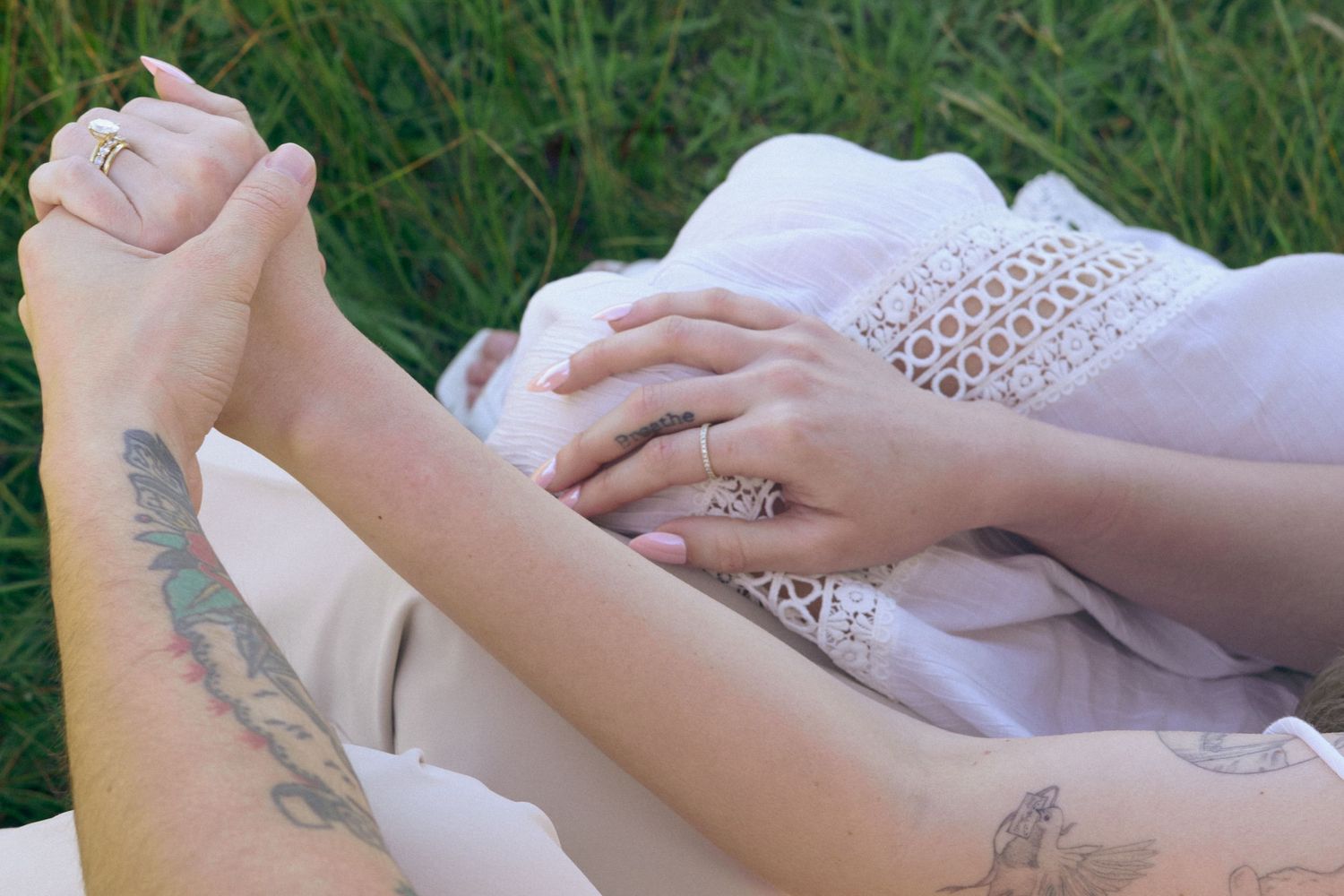 An engaged couple hold hands